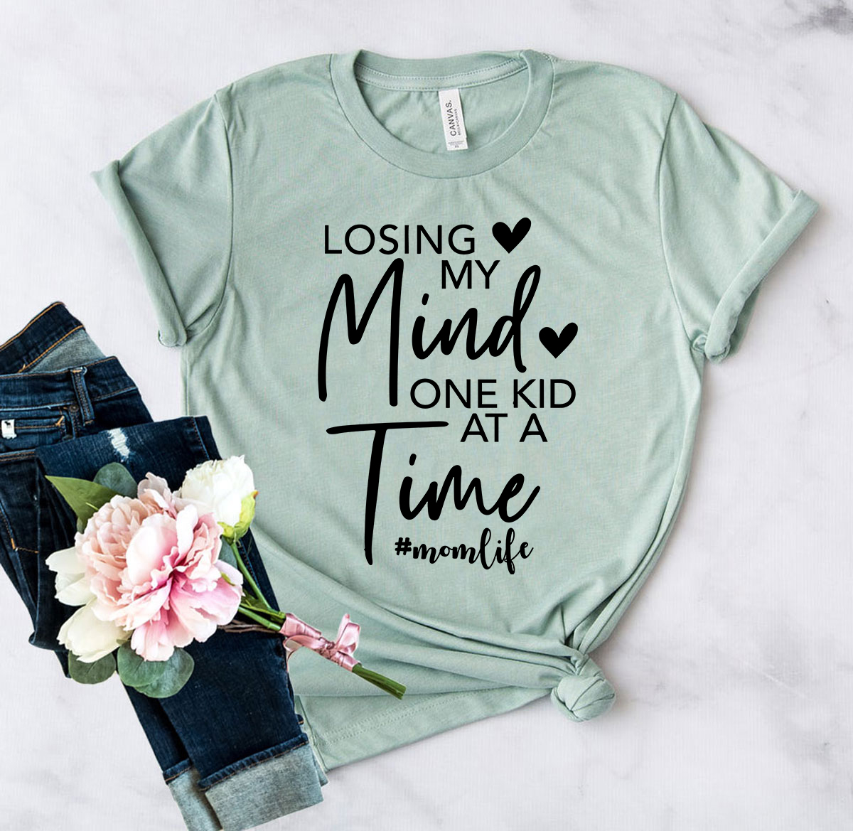 Unisex T-shirt featuring the phrase 'Losing My Mind One Kid At A Time' in a stylish design, available in multiple colors.