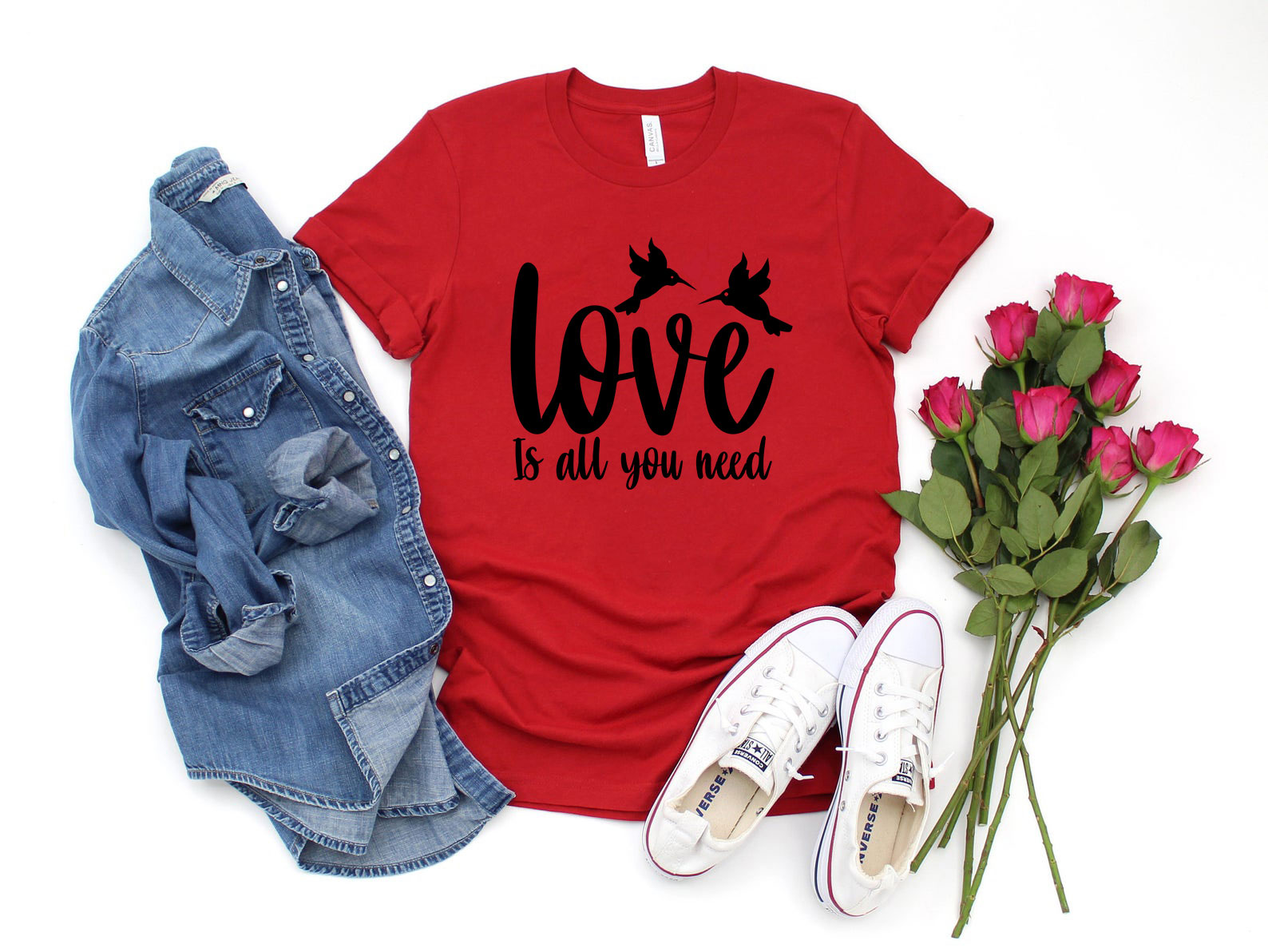 Unisex Love Is All You Need Shirt in various colors, showcasing its soft fabric and stylish design.