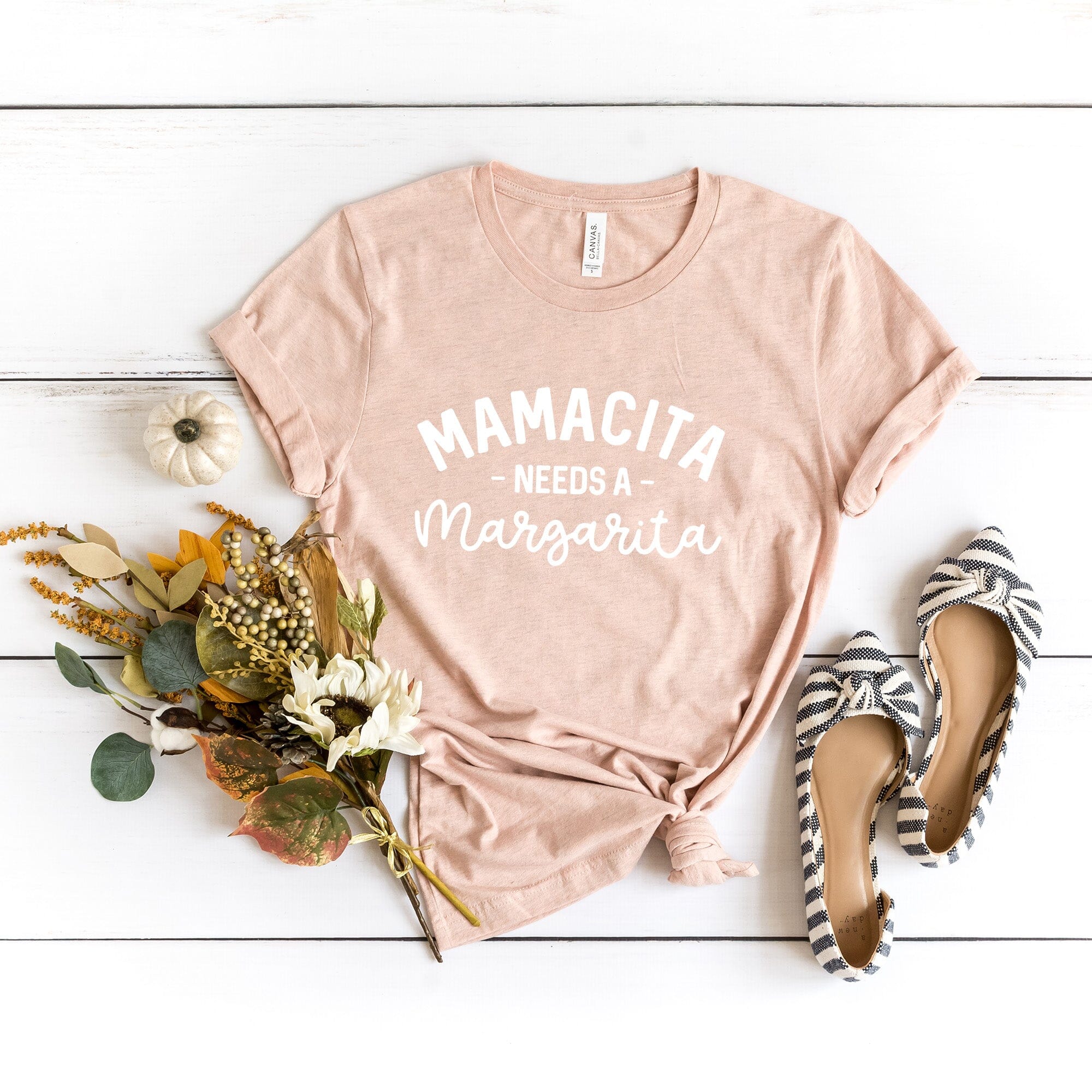 Mamacita Needs a Margarita Tee displayed on a hanger, showcasing its vibrant color and comfortable fabric.