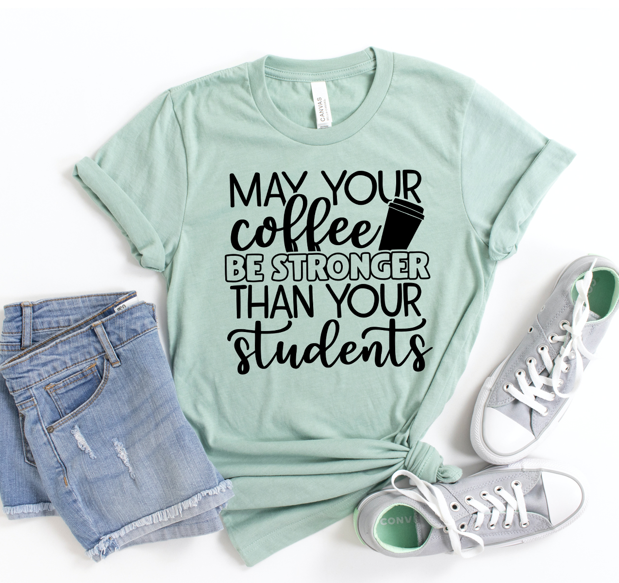 A unisex Bella Canvas t-shirt featuring the phrase 'May Your Coffee Be Stronger Than Your Students' in a stylish font.