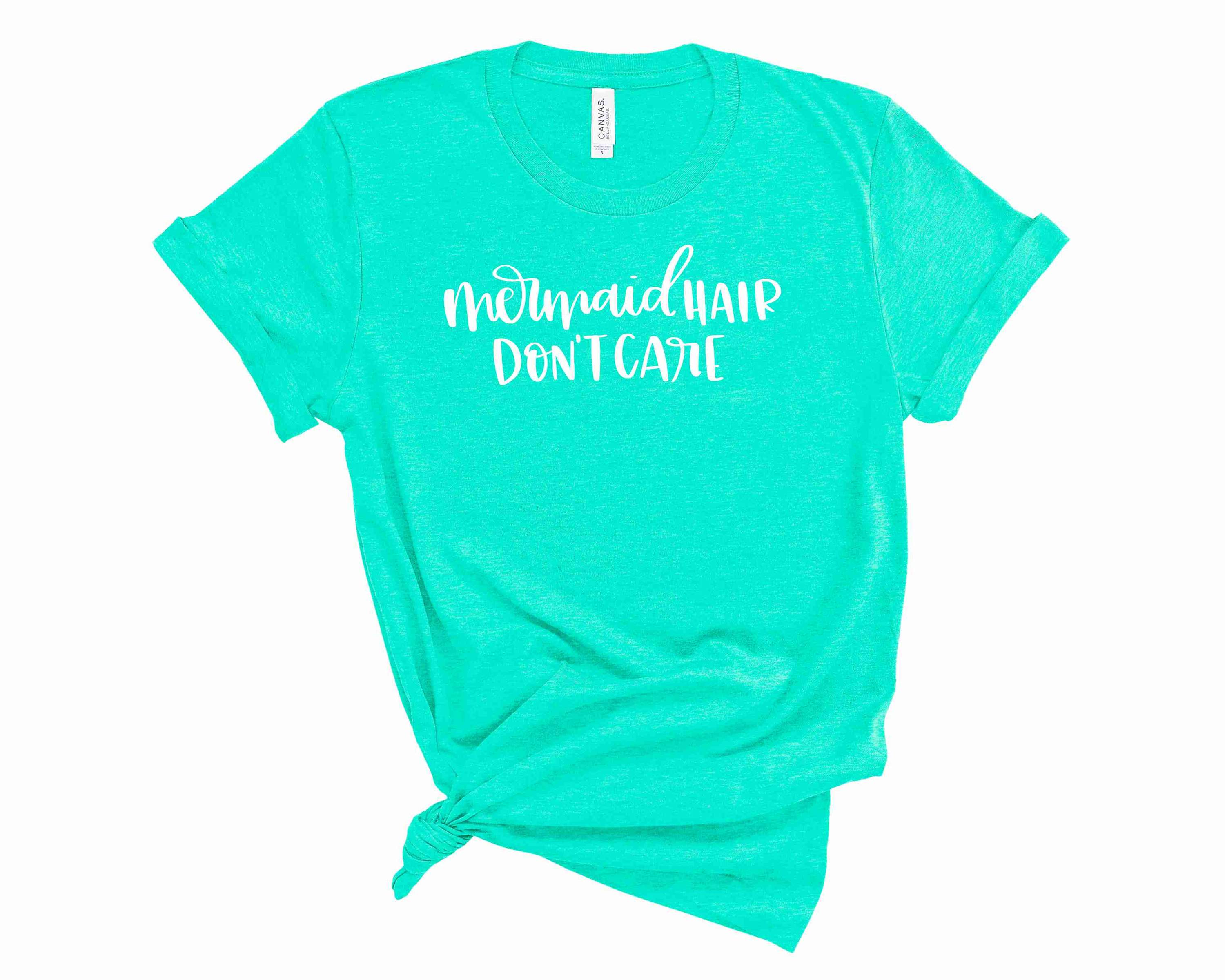 A unisex graphic tee featuring the phrase 'Mermaid Hair Don't Care' in vibrant colors, perfect for casual wear.