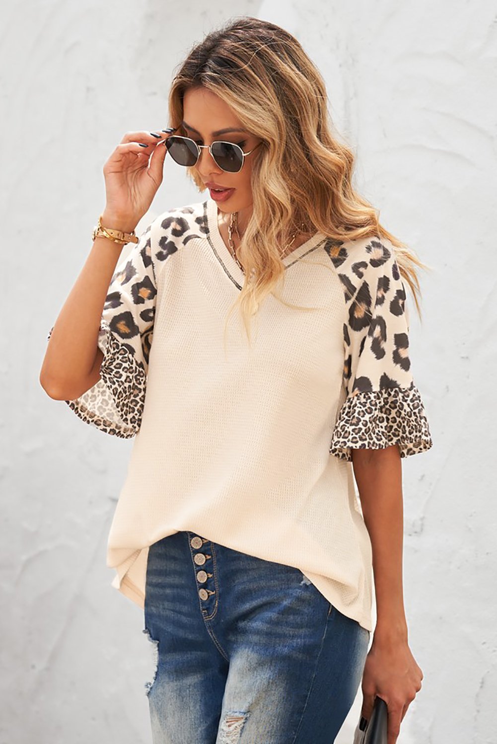 A stylish Mixed Leopard Ruffle Sleeve Waffle V Neck Knit Top featuring a v-neckline, ruffle sleeves, and a bold leopard print design.