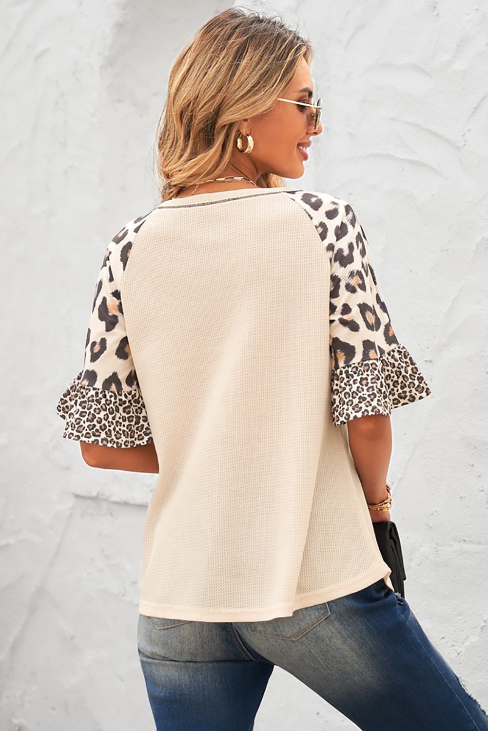 A stylish Mixed Leopard Ruffle Sleeve Waffle V Neck Knit Top featuring a v-neckline, ruffle sleeves, and a bold leopard print design.