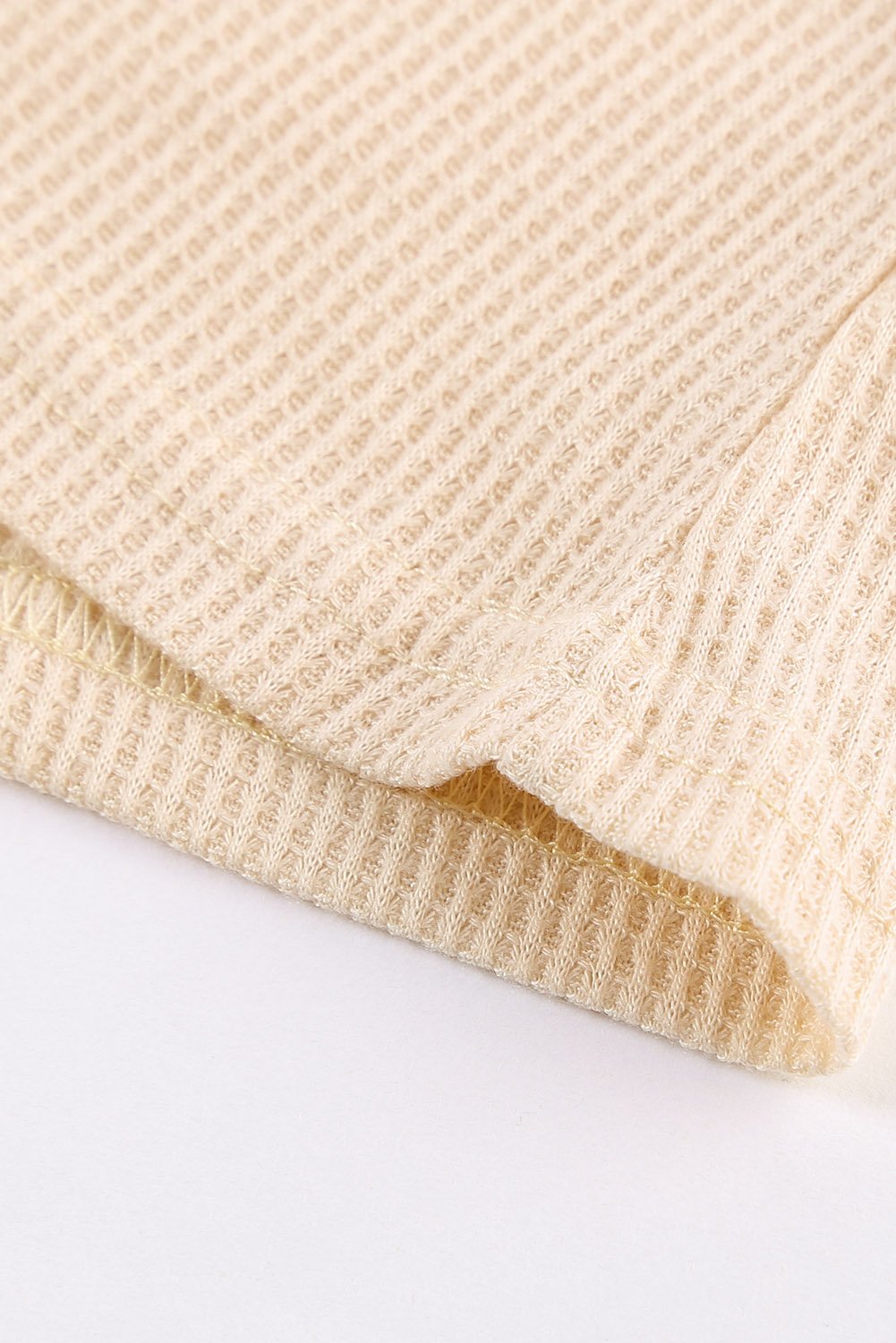 A stylish Mixed Leopard Ruffle Sleeve Waffle V Neck Knit Top featuring a v-neckline, ruffle sleeves, and a bold leopard print design.