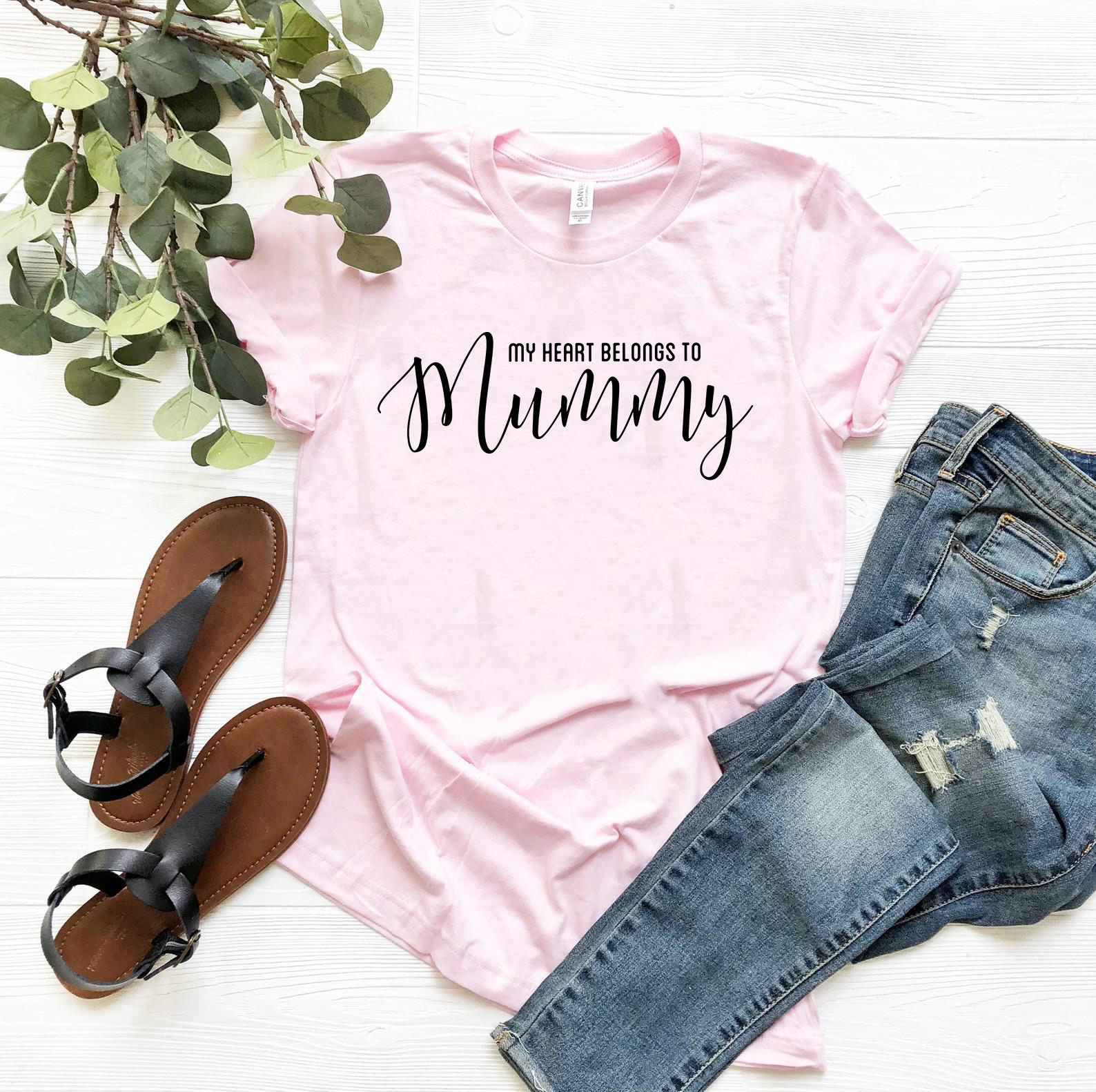 A unisex T-shirt featuring the phrase 'My Heart Belongs To Mummy' in a stylish print, available in various colors.