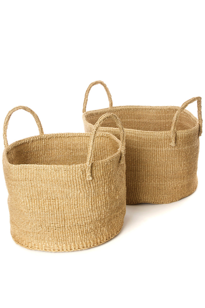 Handwoven natural sisal and fibre African floor storage baskets in cream color, showcasing their unique texture and design.