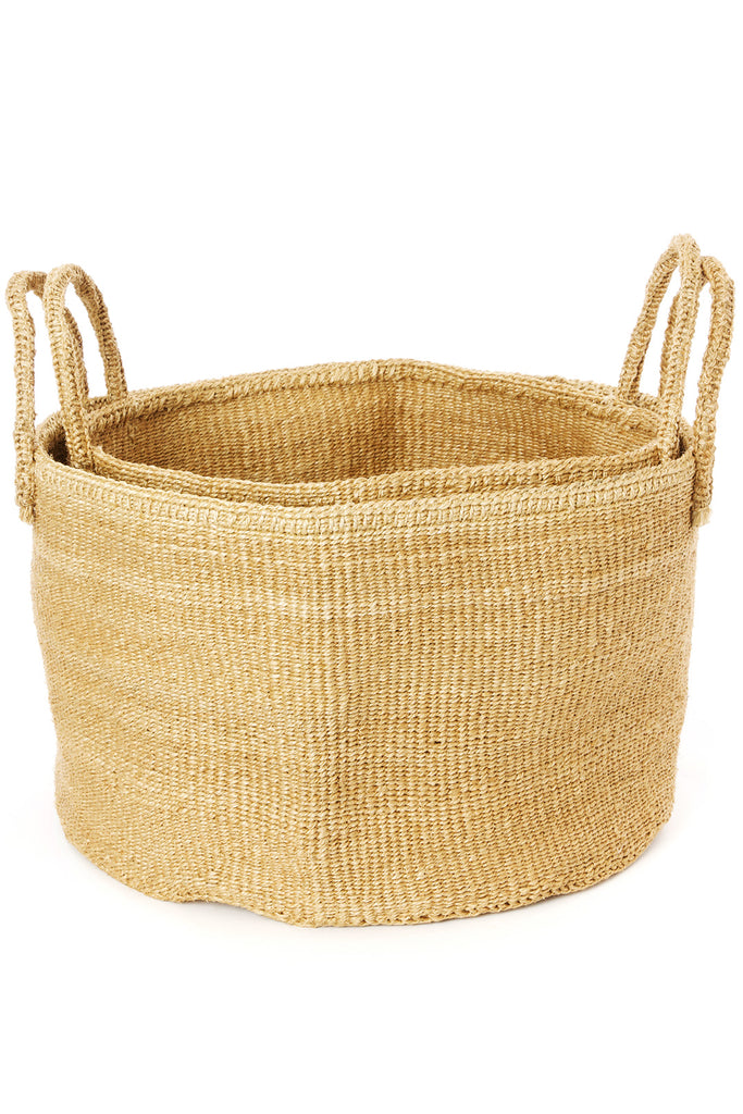 Handwoven natural sisal and fibre African floor storage baskets in cream color, showcasing their unique texture and design.