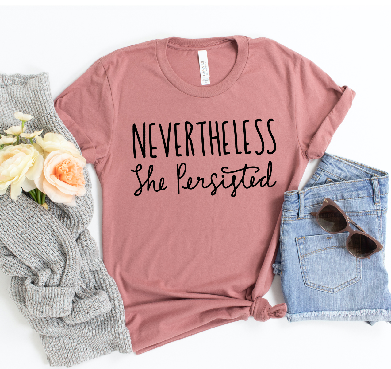 A stylish unisex t-shirt featuring the phrase 'Never The Less She Persisted' printed on a soft, high-quality fabric.