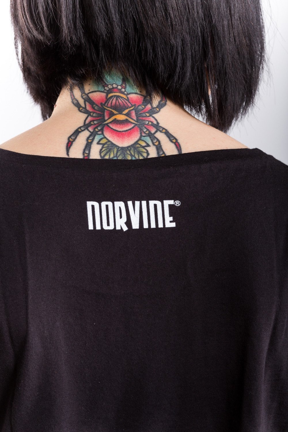 Norvine Masked Rebel Women's Rolled Sleeve Tunic Tee in black, showcasing its crew neck, rolled sleeves, and soft cotton fabric.
