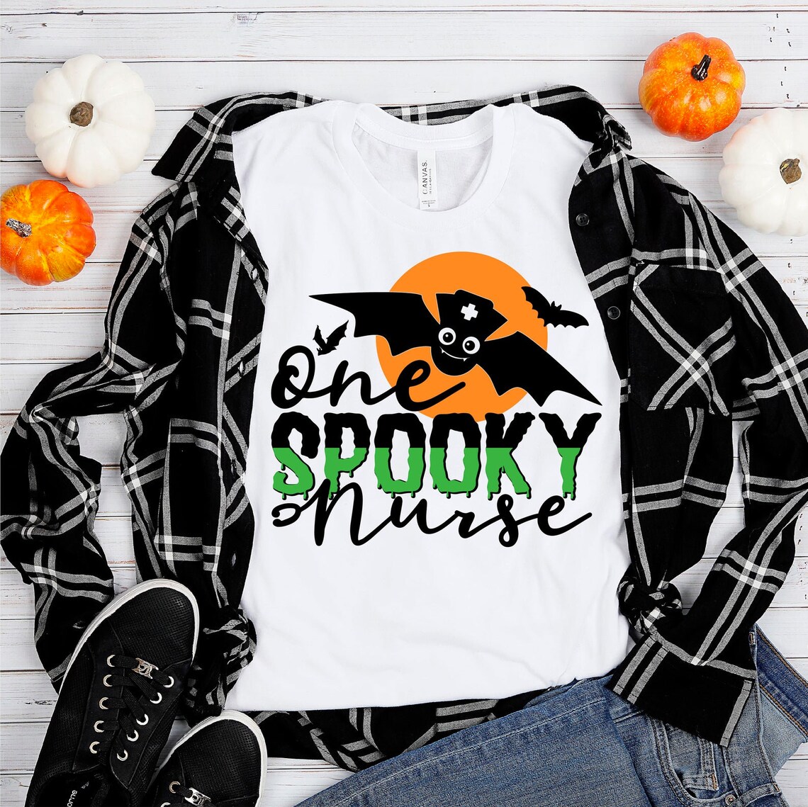 One Spooky Nurse Halloween T-shirt featuring a spooky design, made from premium ring spun cotton, available in various sizes.