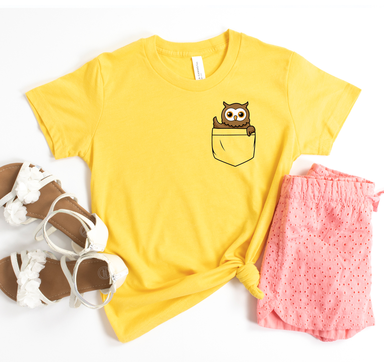 A classic unisex Pocket Owl T-shirt made from soft airlume cotton, displayed on a hanger with a neutral background.