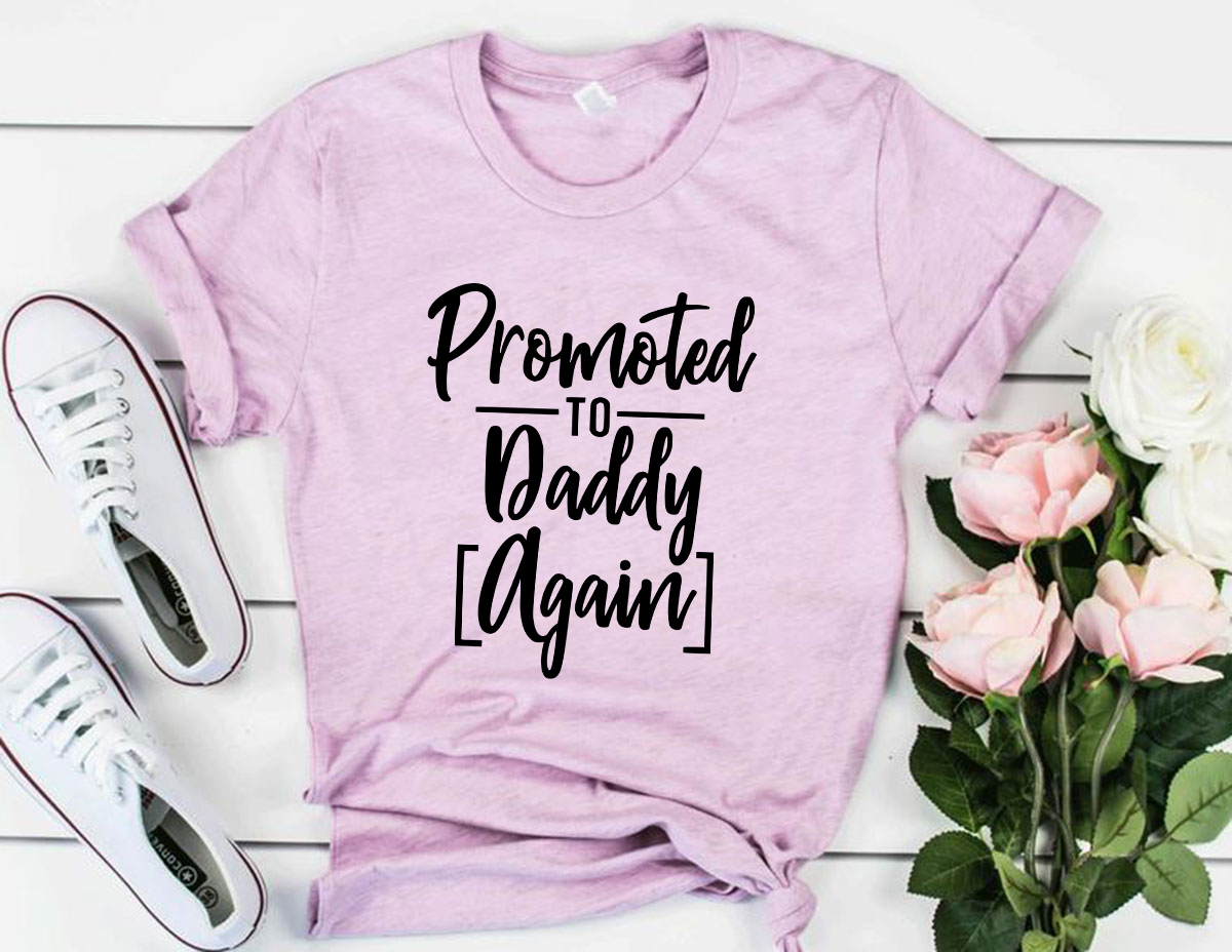 A unisex Promoted To Daddy Again Shirt in various colors, showcasing its soft fabric and stylish design.