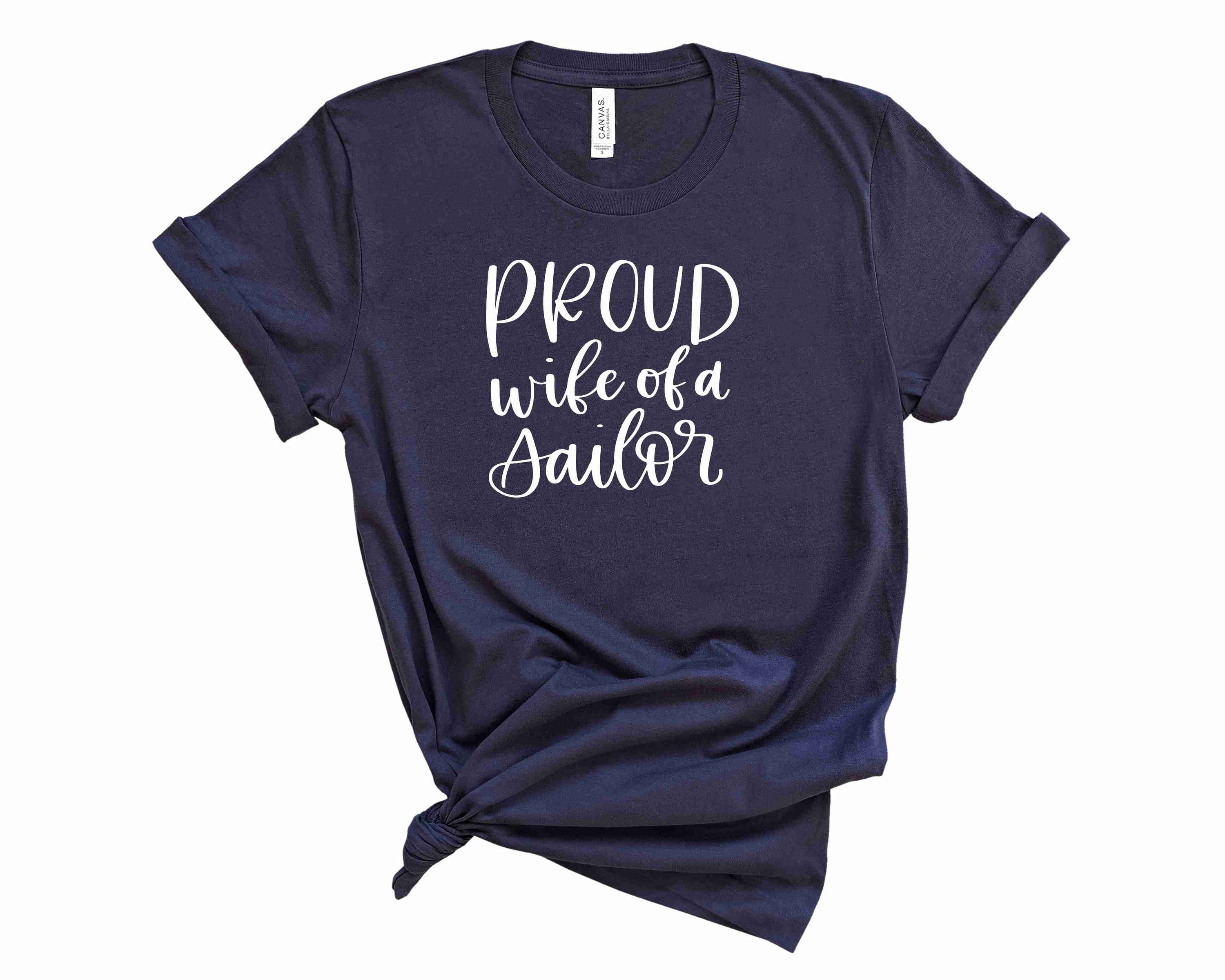 Proud Wife Of A Sailor Graphic Tee displayed on a hanger, showcasing its stylish design and comfortable fabric.