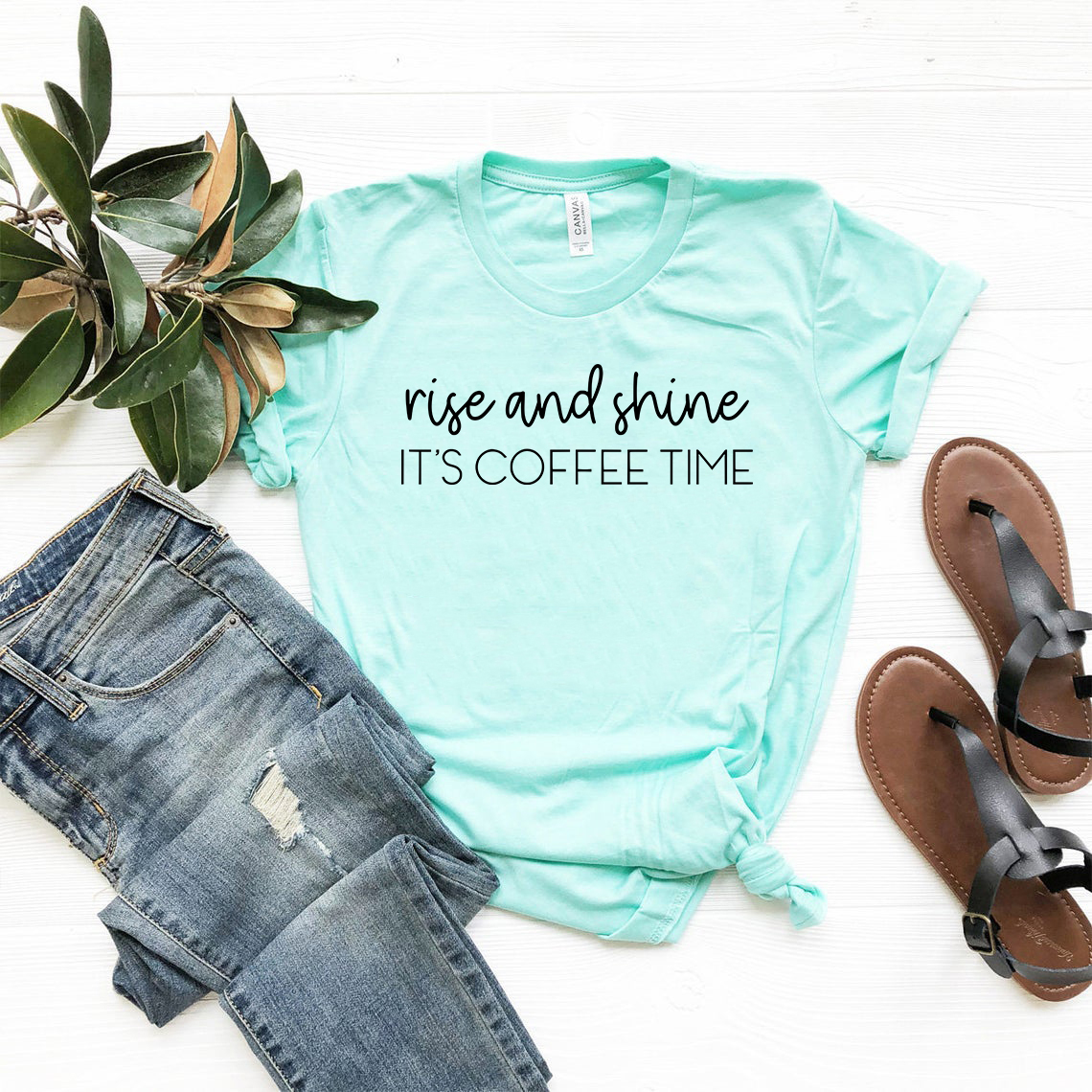 A comfortable unisex T-shirt featuring the phrase 'Rise And Shine Its Coffee Time' in a stylish print, available in multiple colors.