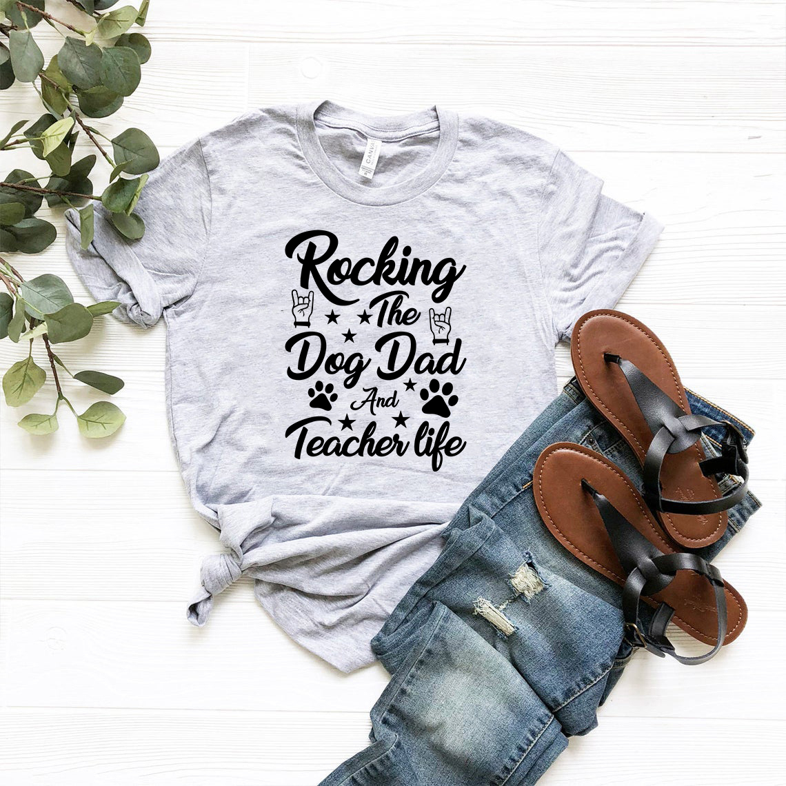Unisex T-shirt featuring 'Rocking The Dog Dad And Teacher Life' design in various colors, made from soft ring spun cotton.