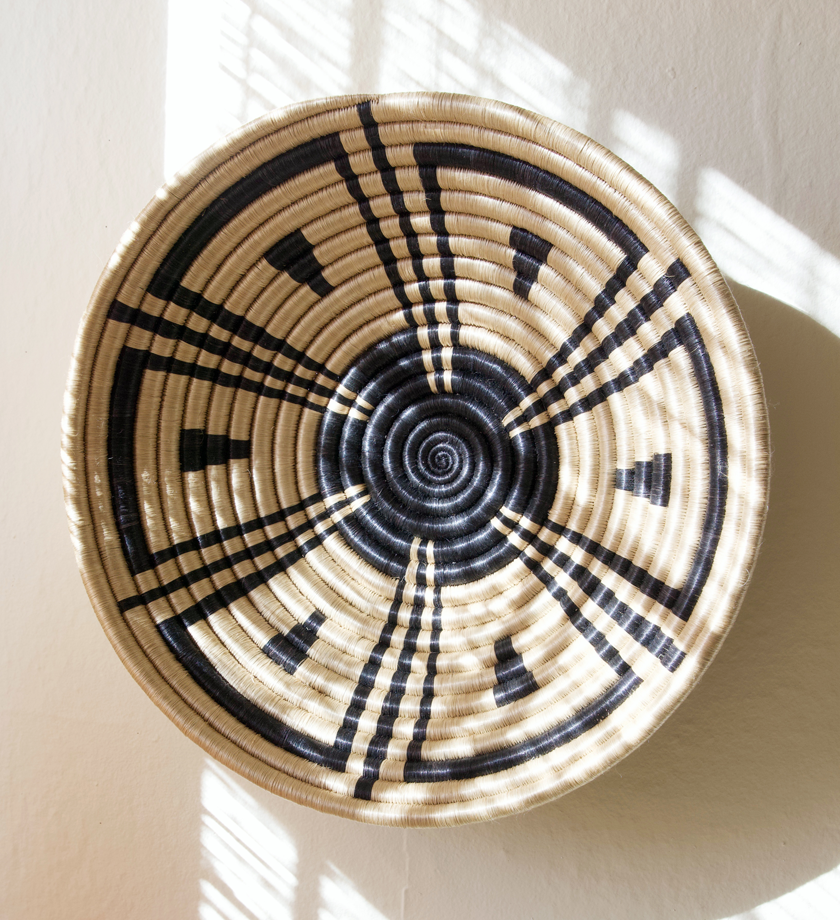 Handcrafted Rwanda inspired sisal basket, showcasing intricate weaving and natural fibers, perfect for storage or decoration.
