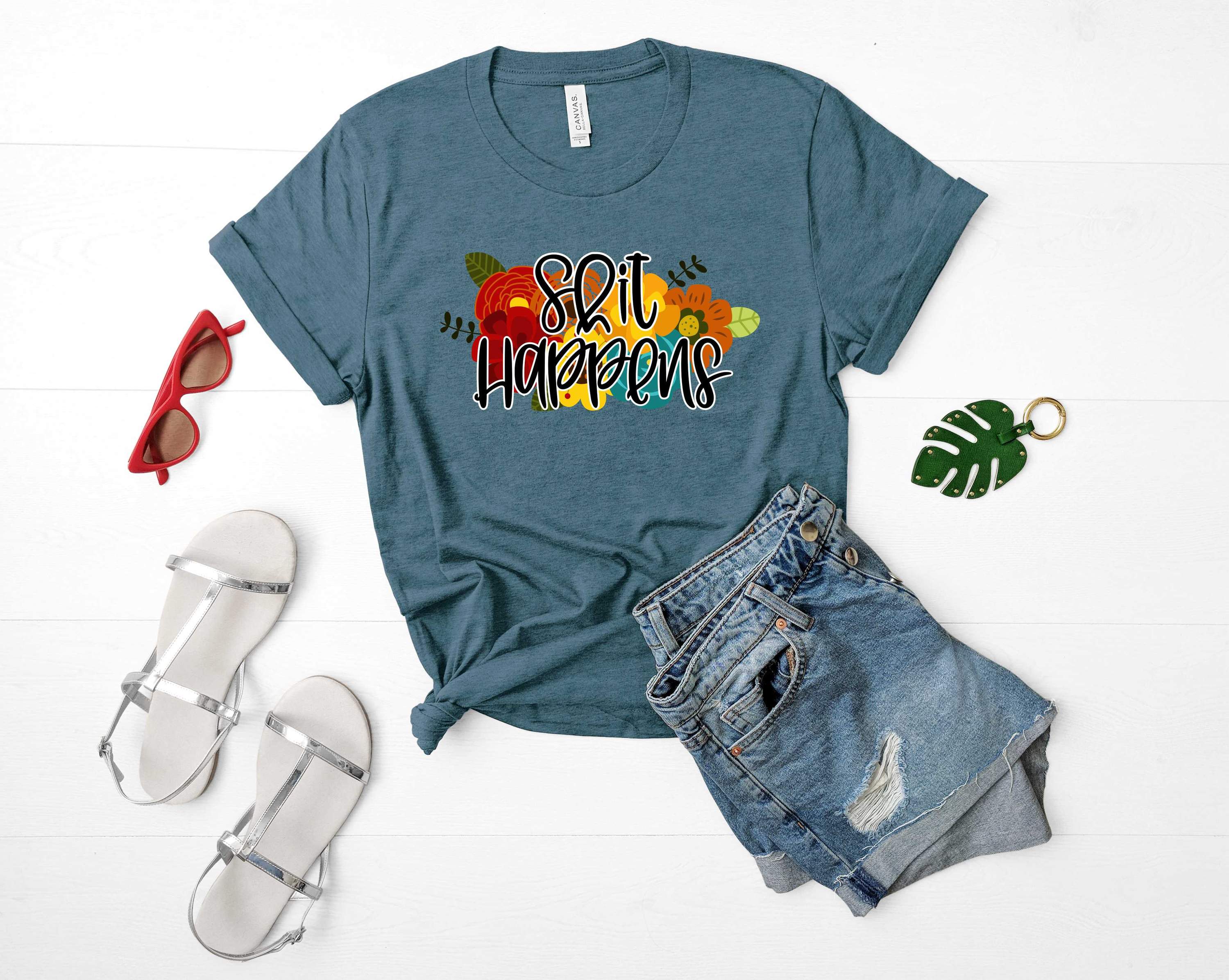 A unisex 'Shit Happens' graphic tee featuring a bold print on a soft fabric, perfect for casual wear.