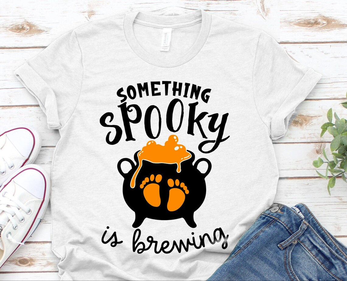 Something Spooky Is Brewing Halloween T-shirt made of premium ring spun cotton with a vibrant print.