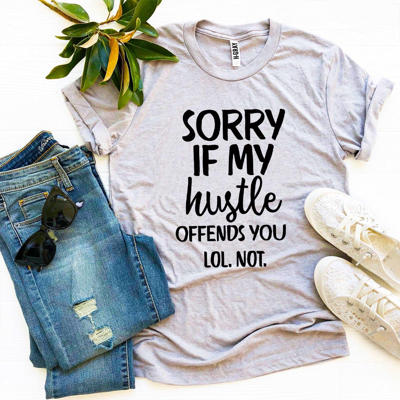 A stylish black t-shirt featuring the phrase 'Sorry If My Hustle Offends You' in bold white text, made from premium ring spun cotton.