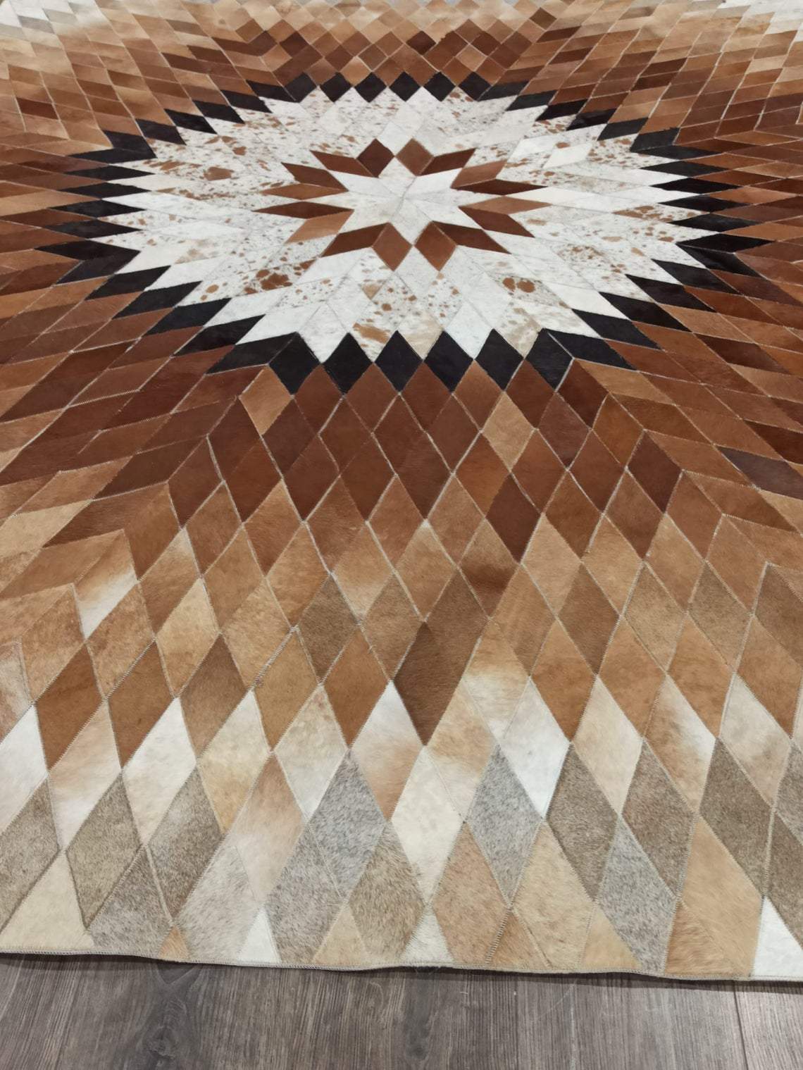 Star Pattern Cow Skin Rug showcasing a unique zigzag design in natural cowhide, perfect for enhancing home decor.
