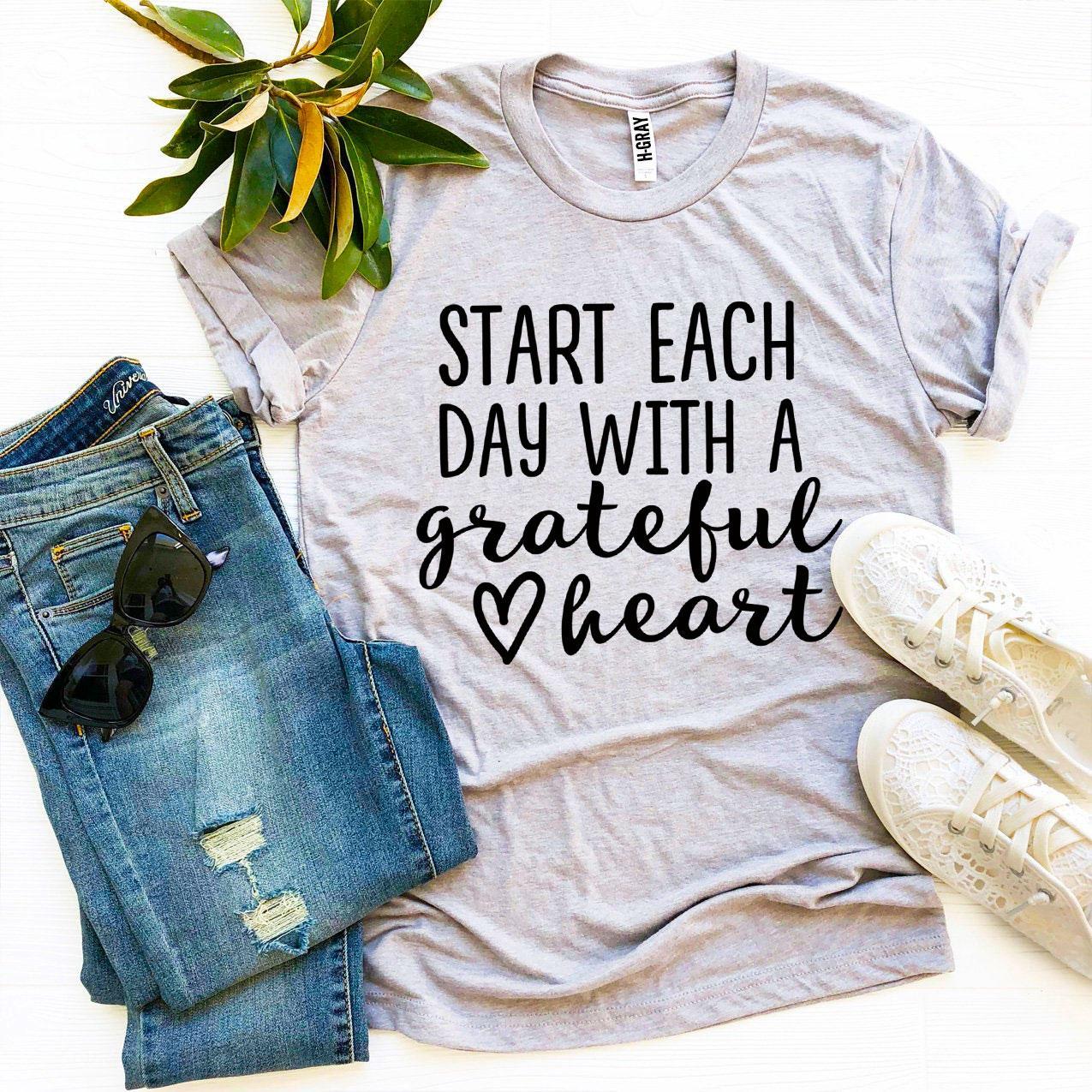 A soft and stylish t-shirt featuring the phrase 'Start Each Day With a Grateful Heart', made from premium ring spun cotton.