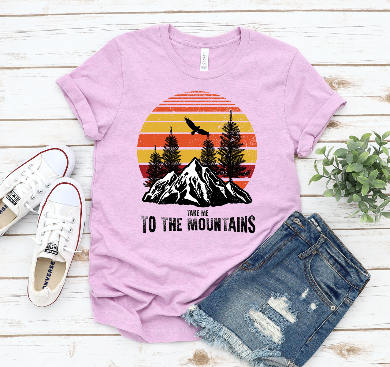 Take Me To The Mountains T-shirt in a scenic outdoor setting, showcasing its unisex design and soft fabric.