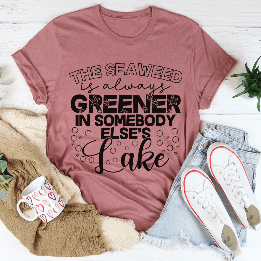 A classic unisex short sleeve tee featuring the phrase 'The Seaweed Is Always Greener In Somebody Else's Lake' in vibrant colors on soft cotton fabric.
