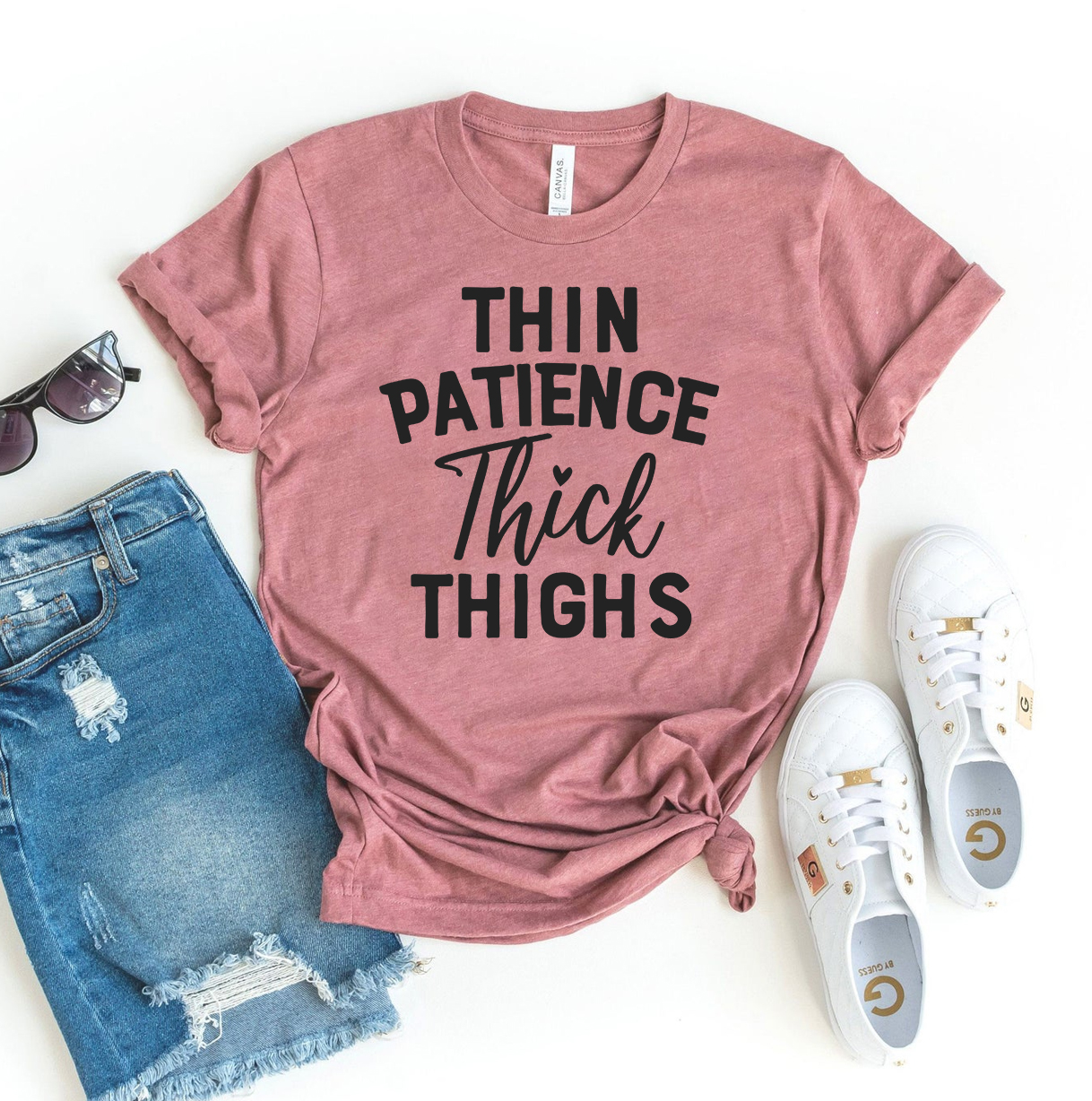 Thin Patience Thick Thighs T-shirt displayed on a mannequin, showcasing its soft fabric and vibrant print design.