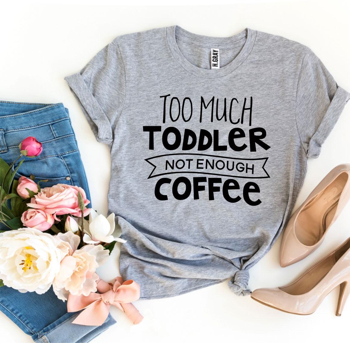 A stylish black t-shirt with the phrase 'Too Much Toddler Not Enough Coffee' printed in bold white letters, showcasing a fun design for parents.
