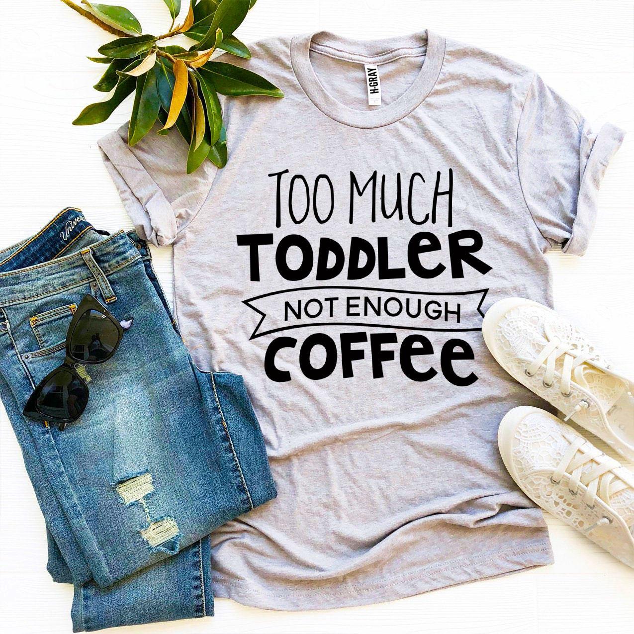 A stylish black t-shirt with the phrase 'Too Much Toddler Not Enough Coffee' printed in bold white letters, showcasing a fun design for parents.