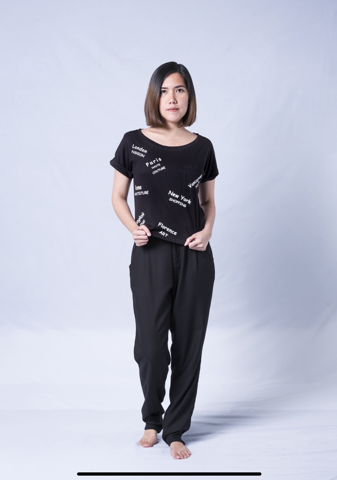 A soft and stylish Travel Graphic Top featuring a wide neck and rolled sleeves, perfect for casual wear.