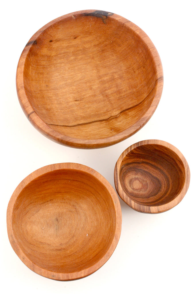 Trio Olive Wood Condiment Bowls, hand-carved from solid olive wood, showcasing unique grain patterns and three different sizes.