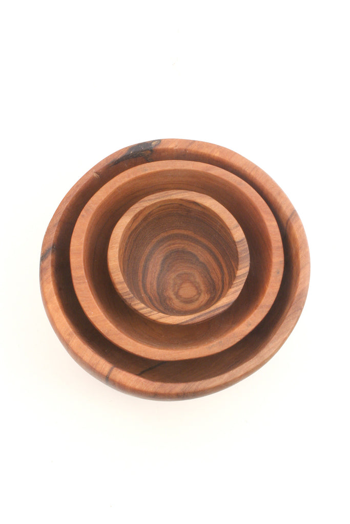 Trio Olive Wood Condiment Bowls, hand-carved from solid olive wood, showcasing unique grain patterns and three different sizes.