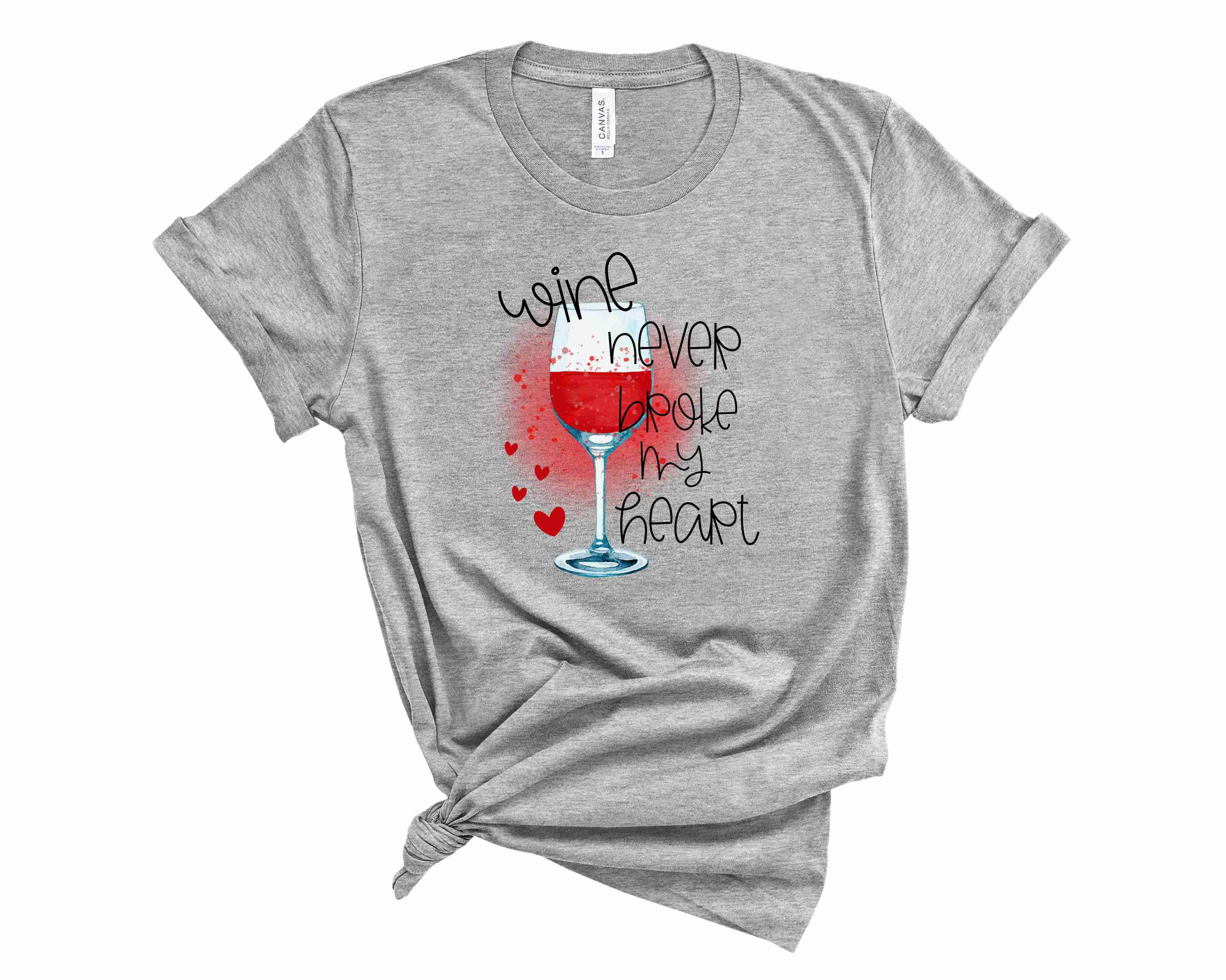 A stylish unisex graphic tee featuring the phrase 'Wine Never Broke My Heart' in bold letters, perfect for wine enthusiasts.
