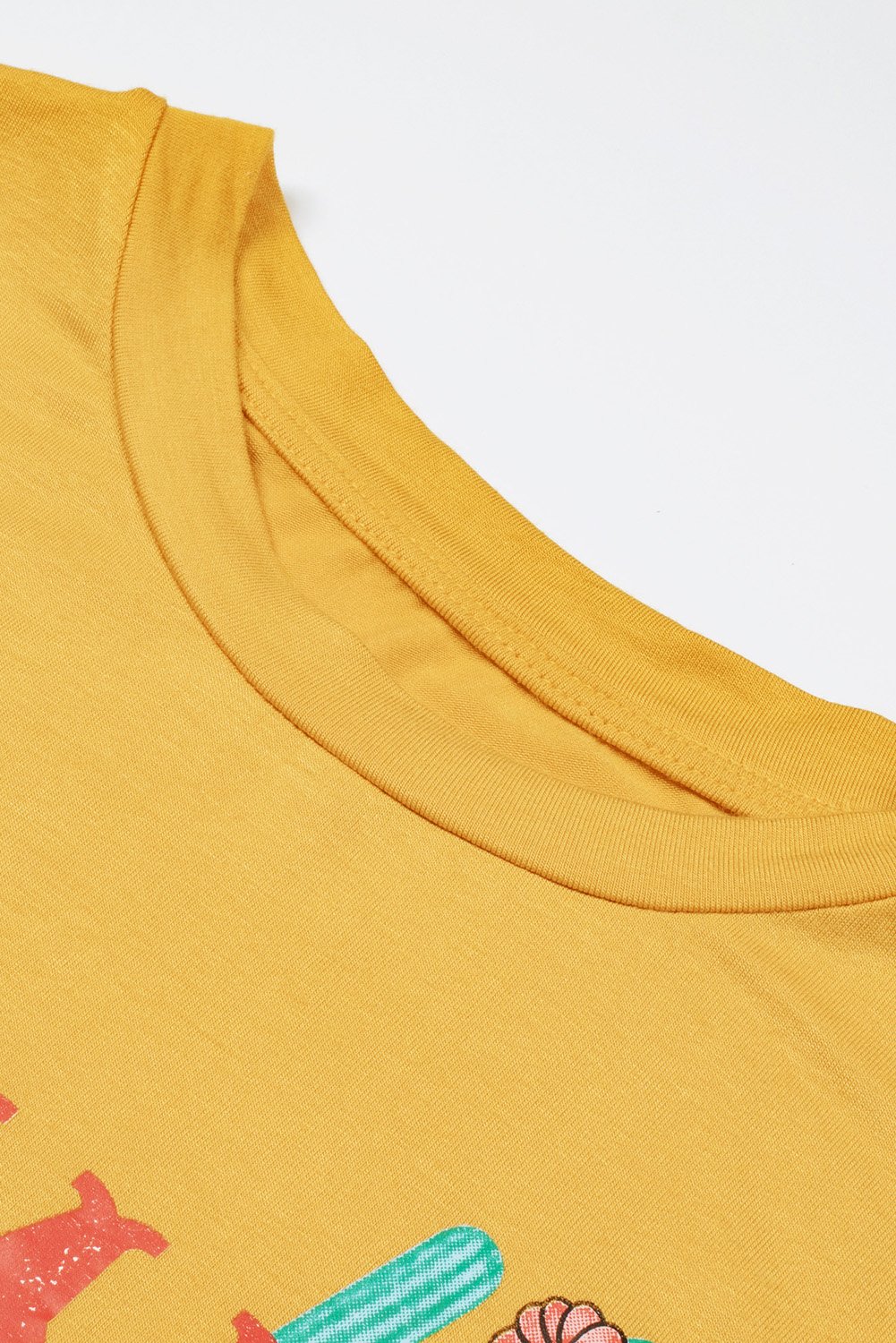 Women wearing a yellow Mamacita casual tee with cactus print, showcasing a stylish summer look.