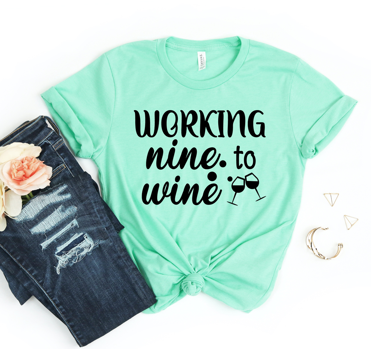 A stylish unisex Working Nine To Wine T-shirt made from soft cotton, featuring a fun wine-themed slogan.
