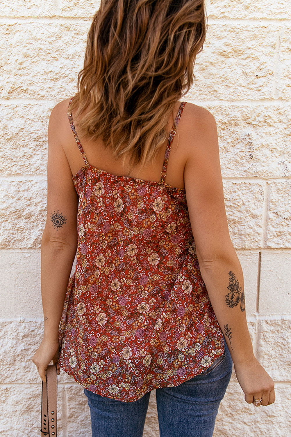 A stylish red floral print cami top with spaghetti straps, showcasing a vibrant floral pattern, perfect for summer wear.