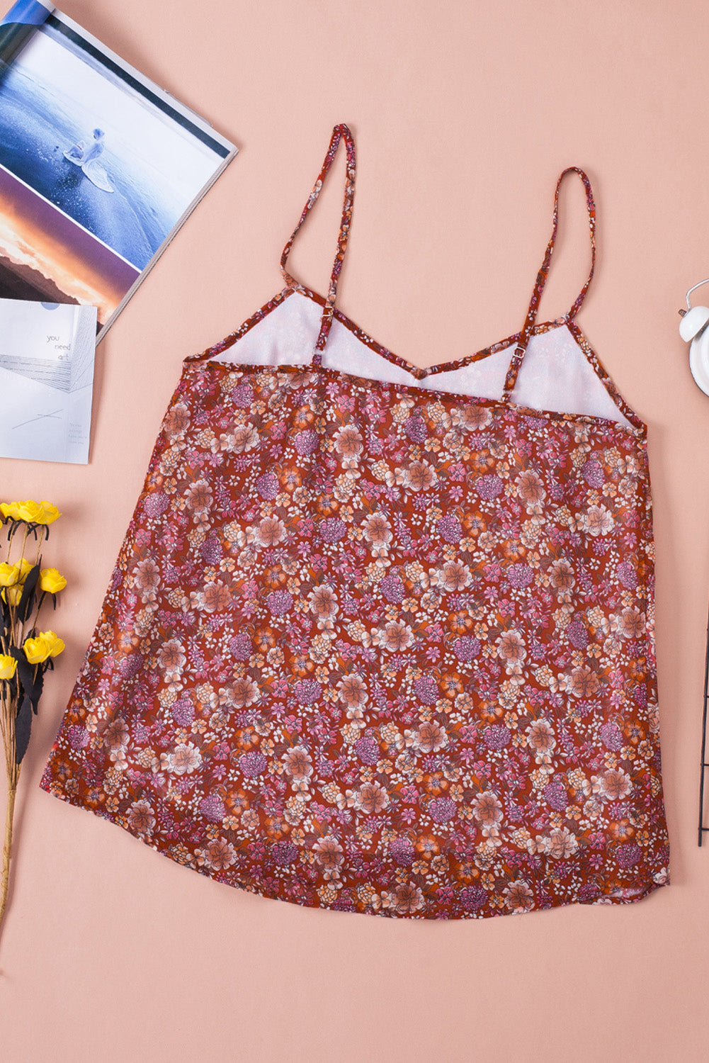 A stylish red floral print cami top with spaghetti straps, showcasing a vibrant floral pattern, perfect for summer wear.