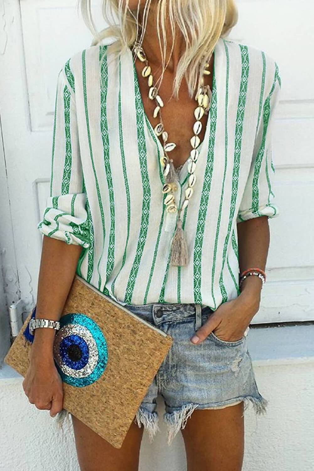 A stylish green button-up long sleeve blouse with a v-neckline and tribal striped pattern, perfect for casual and formal occasions.