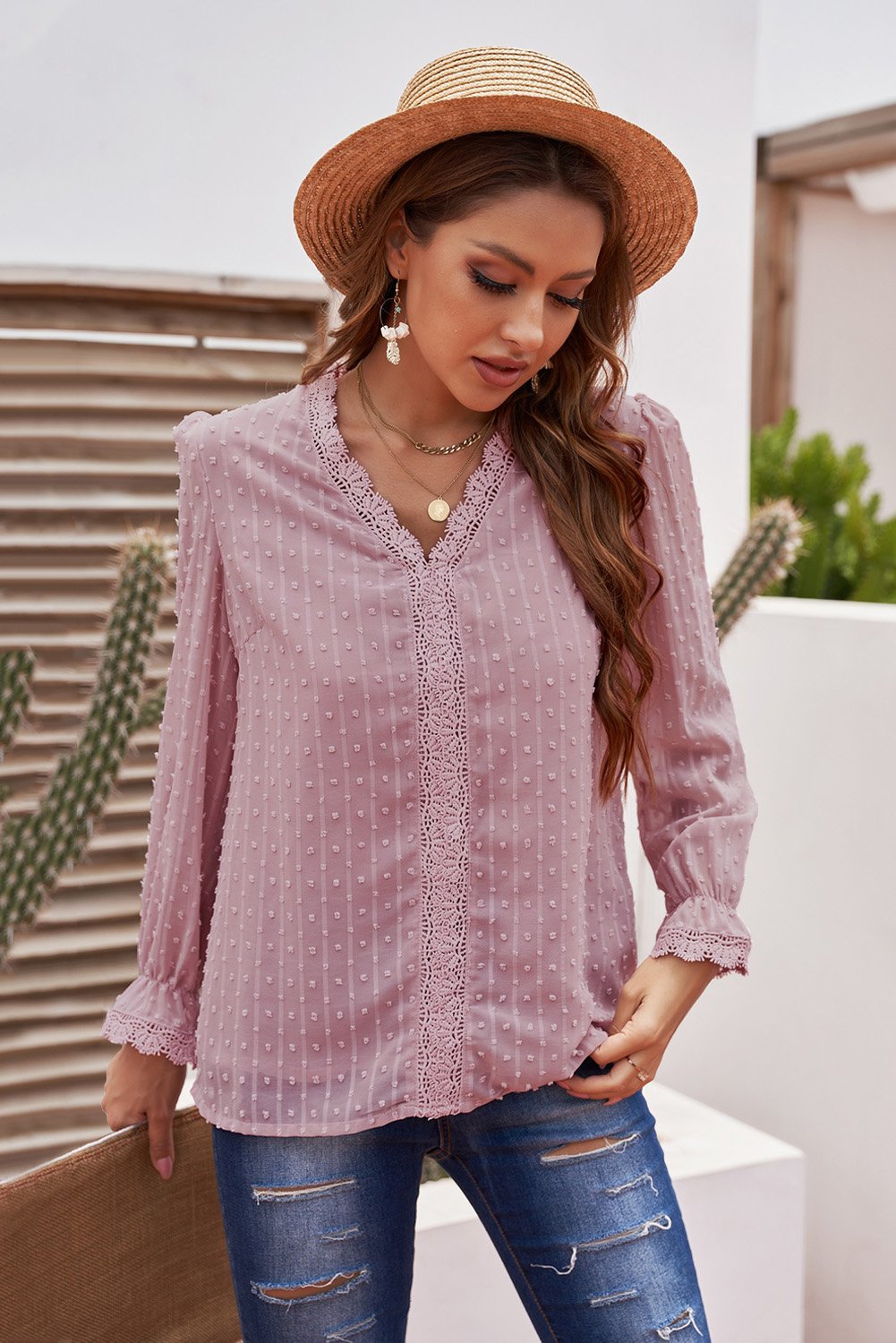 Chic pink long sleeve blouse featuring a v-neck and swiss dot lace details, perfect for casual and formal occasions.