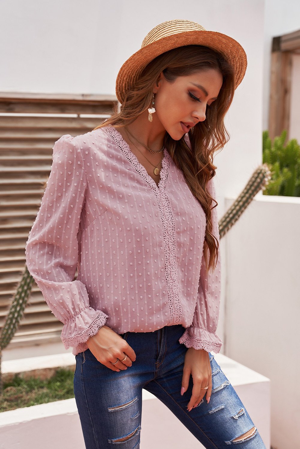 Chic pink long sleeve blouse featuring a v-neck and swiss dot lace details, perfect for casual and formal occasions.