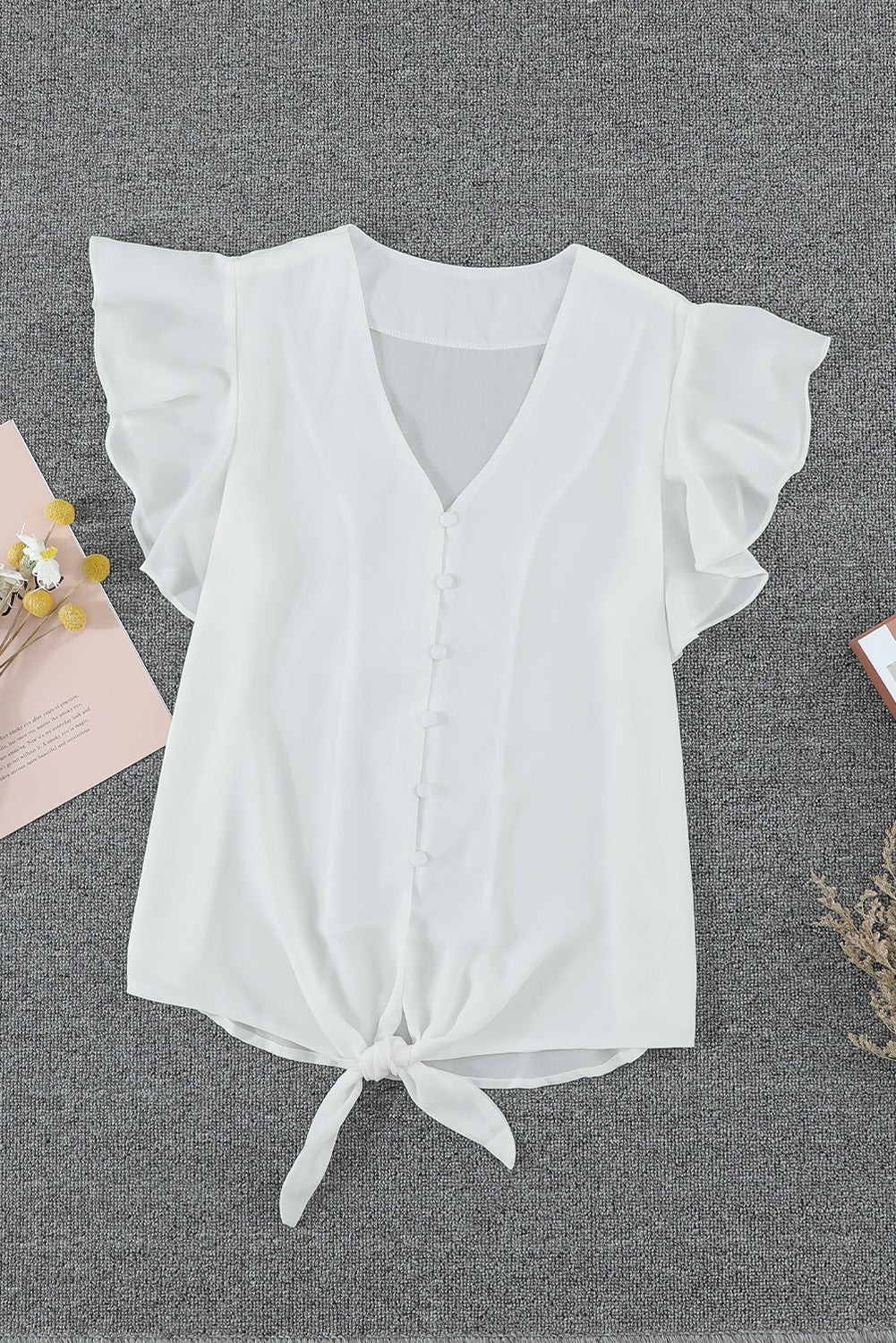 Chic white short sleeve button down tie top with deep V-neckline and fluttering sleeves, perfect for summer fashion.