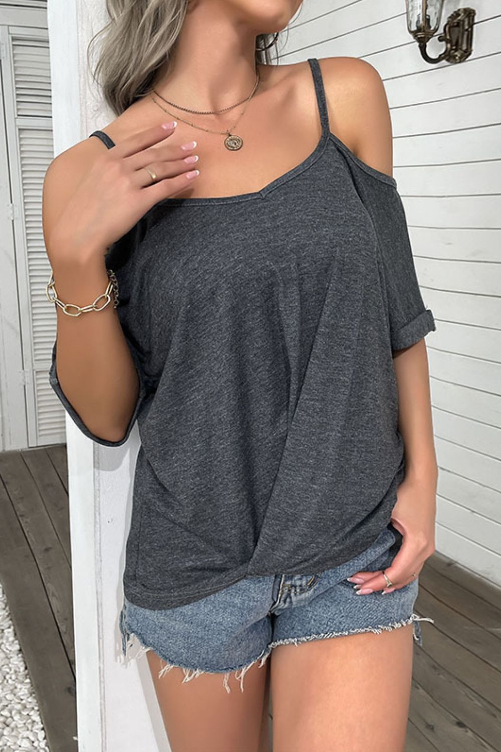 A stylish cold-shoulder twist front tee shirt in solid color, showcasing its trendy design and comfortable fit.