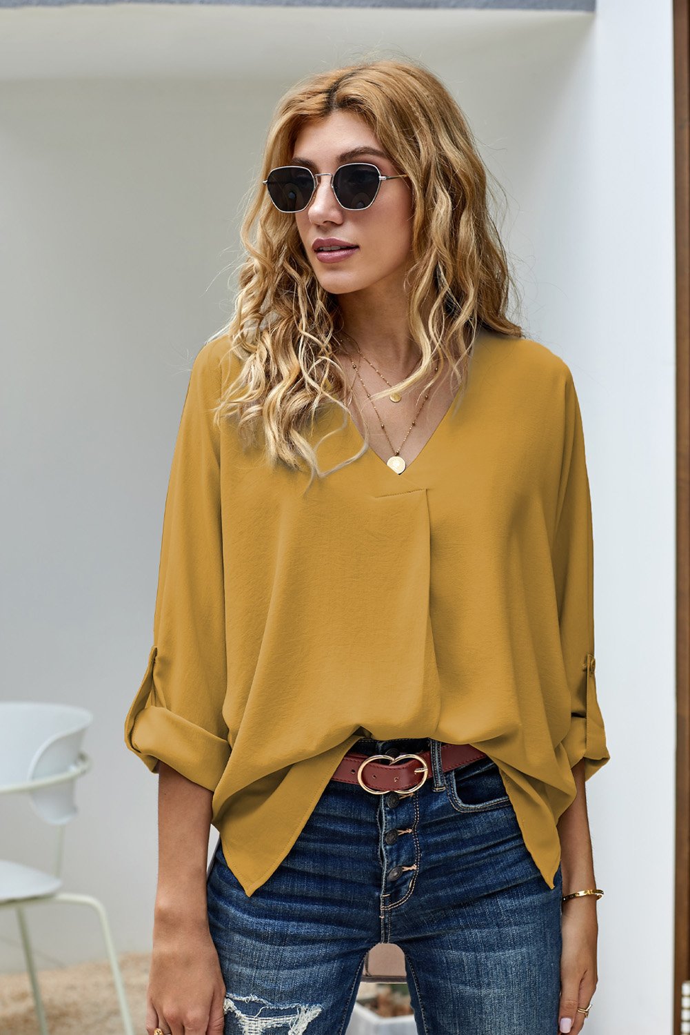 Elegant yellow blouse with v-neck and 3/4 sleeves, featuring a high low hem design, perfect for casual wear.