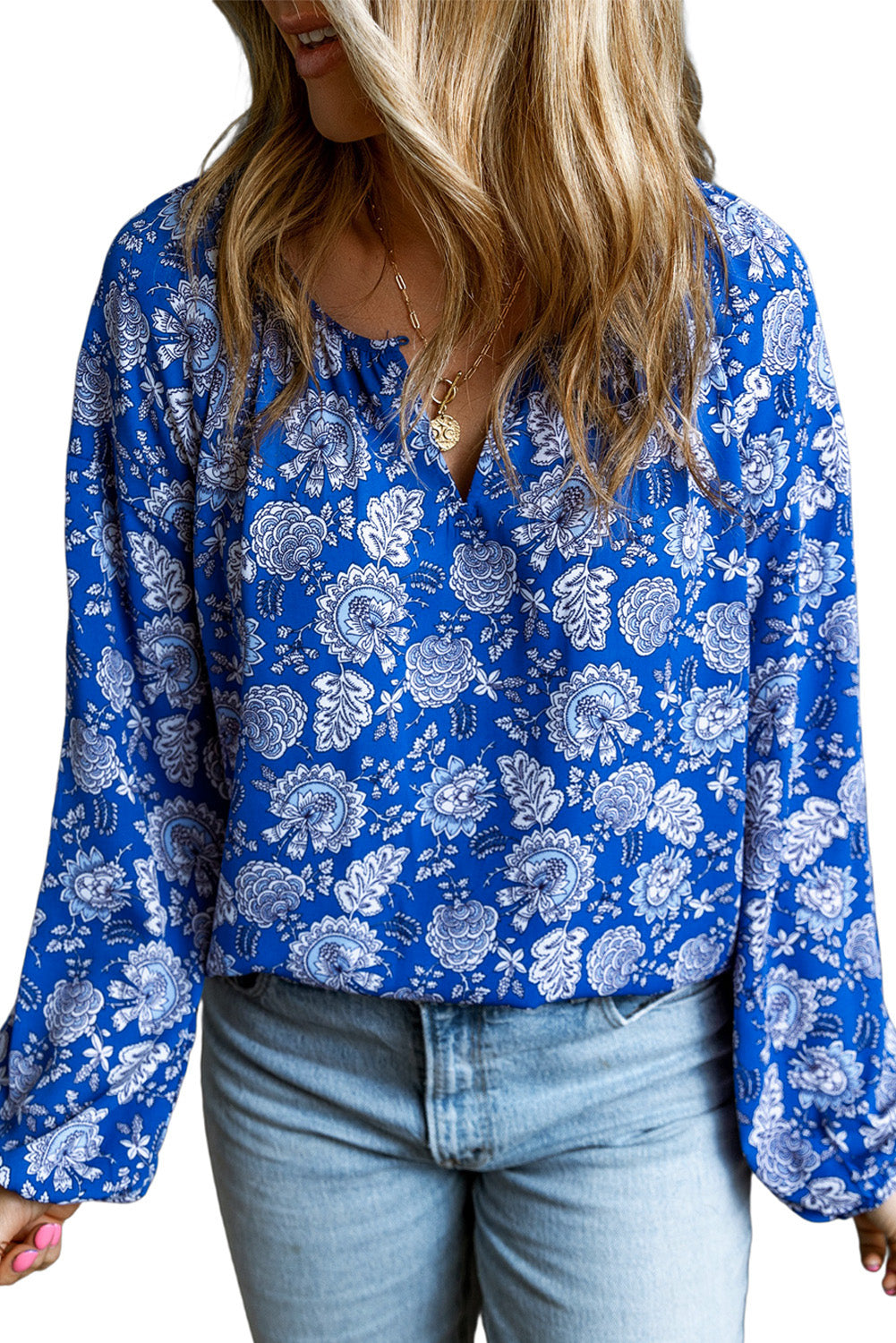 Floral Notched V-Neck Long Sleeve Blouse featuring a vibrant floral print and a comfortable loose fit, ideal for various occasions.