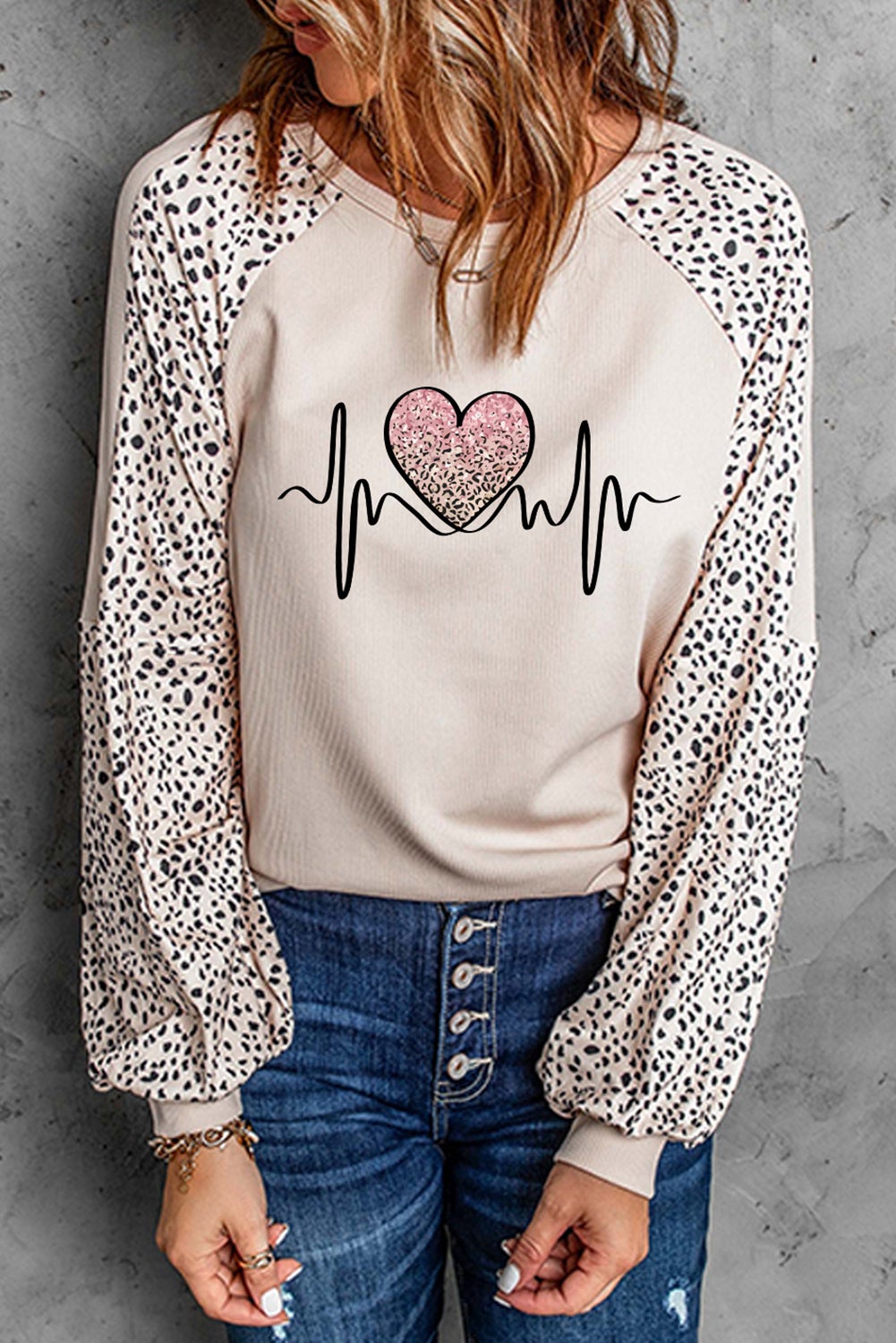 Peaceful Love Leopard Pullover Top featuring a stylish leopard and heart pattern, long sleeves, and a round neckline, perfect for casual wear.