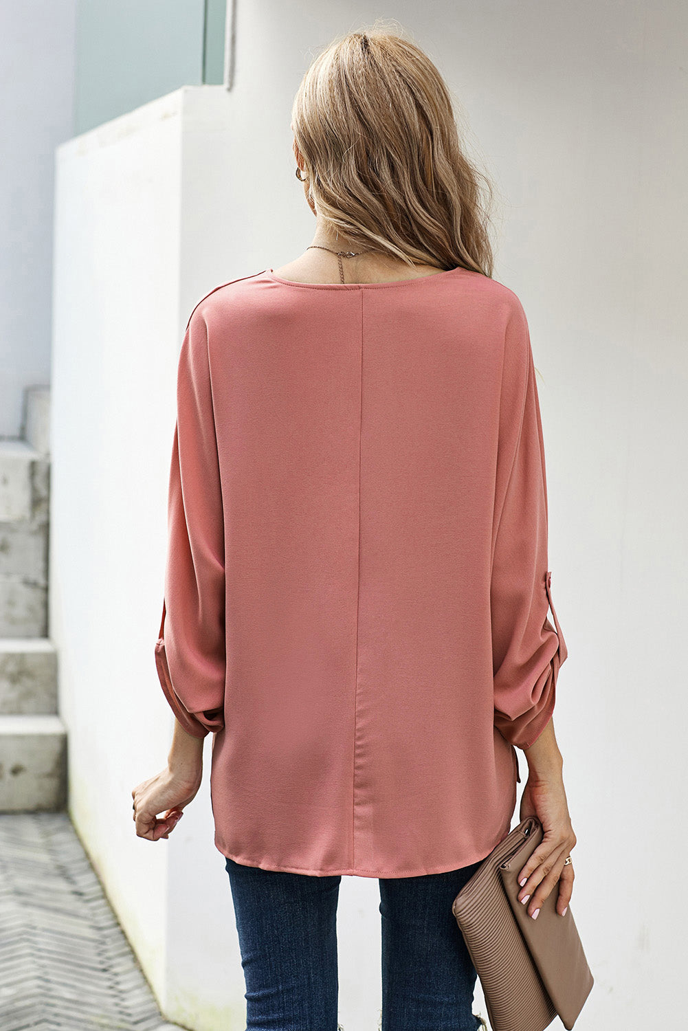 A stylish pink v-neck shirt with 3/4 sleeves and a high low hem, perfect for casual wear in spring and autumn.