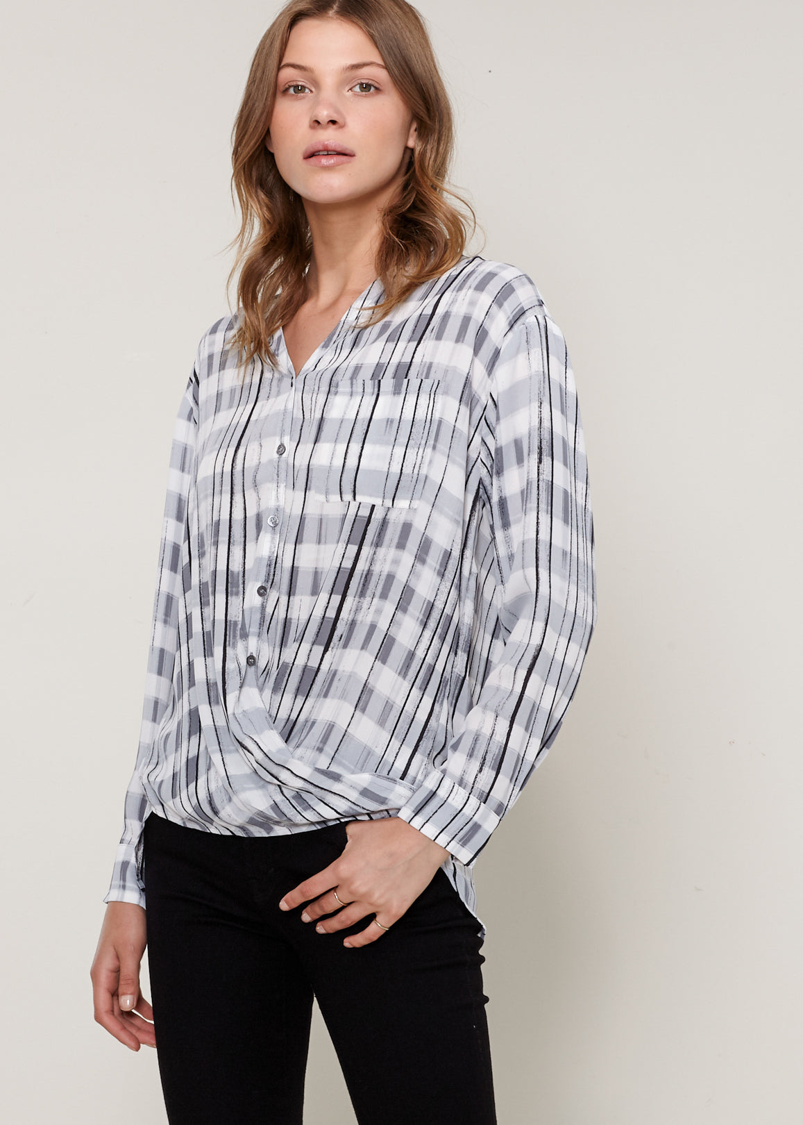 A stylish Printed Wrap Hem Blouse featuring a V-neck, button-down front, and a hi-lo wrap hem design, perfect for casual or professional wear.