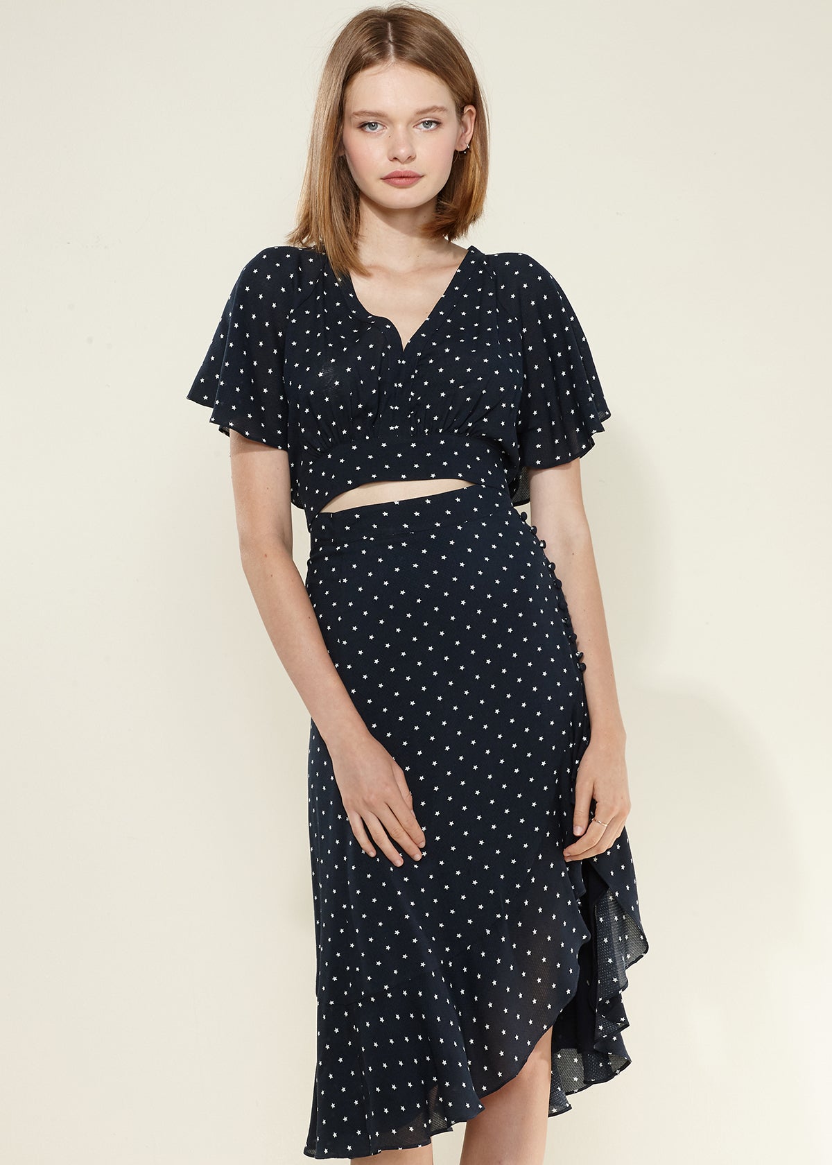 Women's navy cape sleeve V-neck crop blouse with stylish design and rear tie detail.