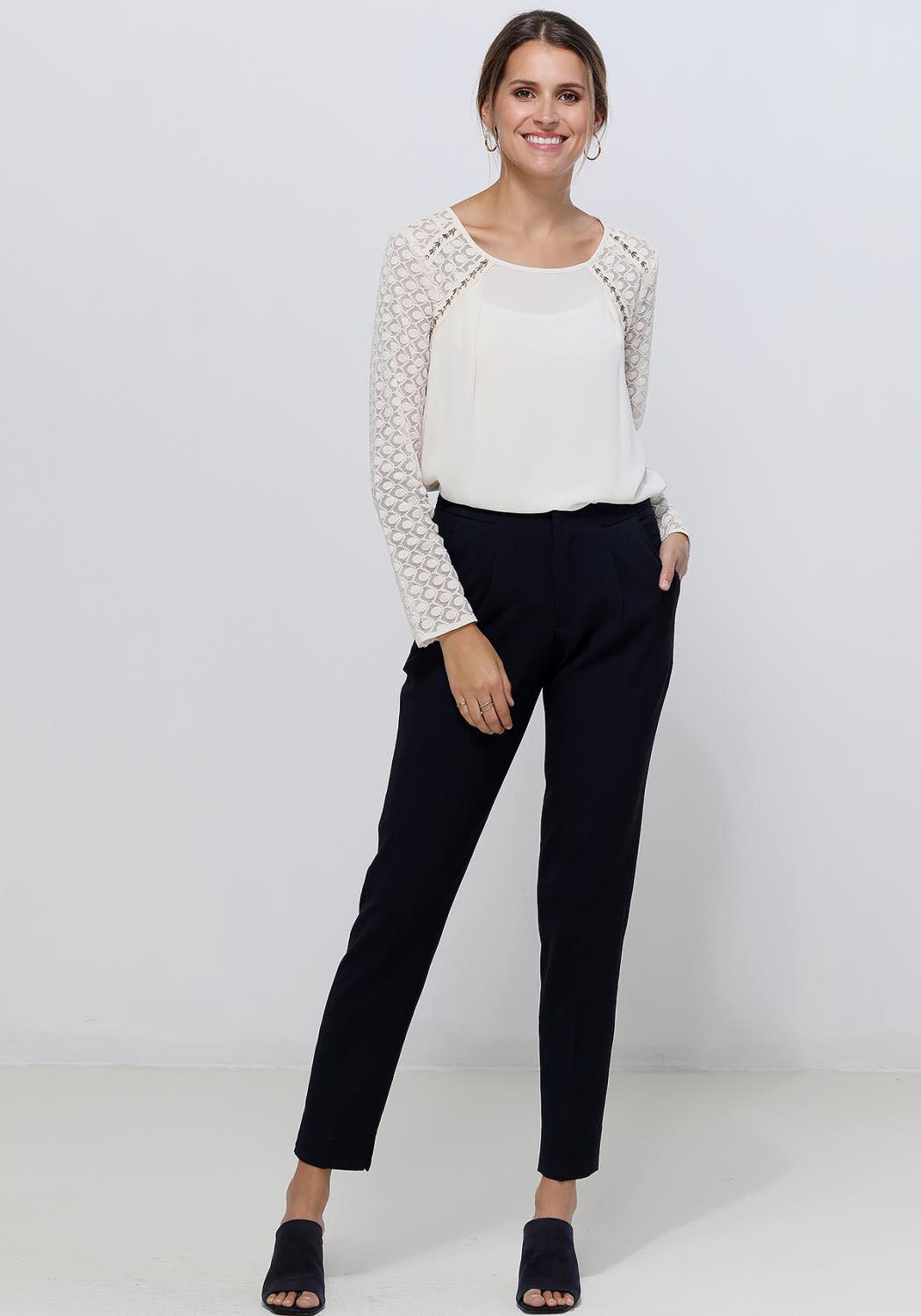 Women's cream blouse featuring lace trim long sleeves and button back closure, perfect for elegant occasions.